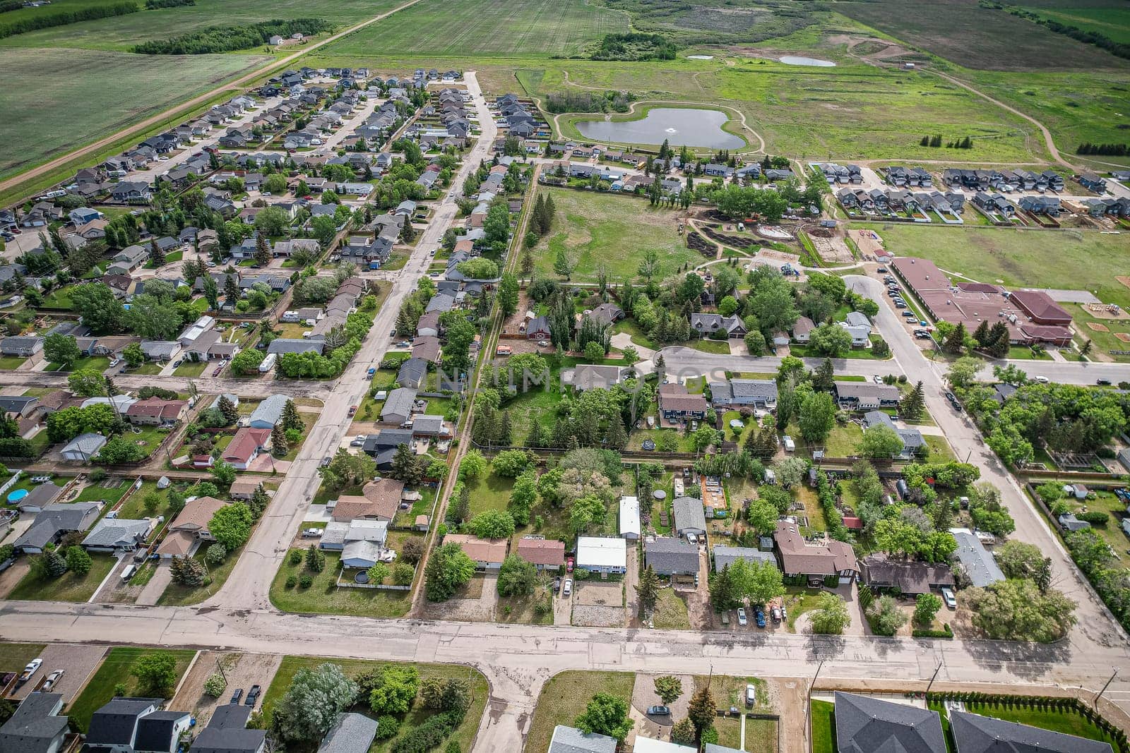 Drone image capturing the town of Dalmeny in Saskatchewan during the summer season, showcasing its vibrant greenery and serene atmosphere