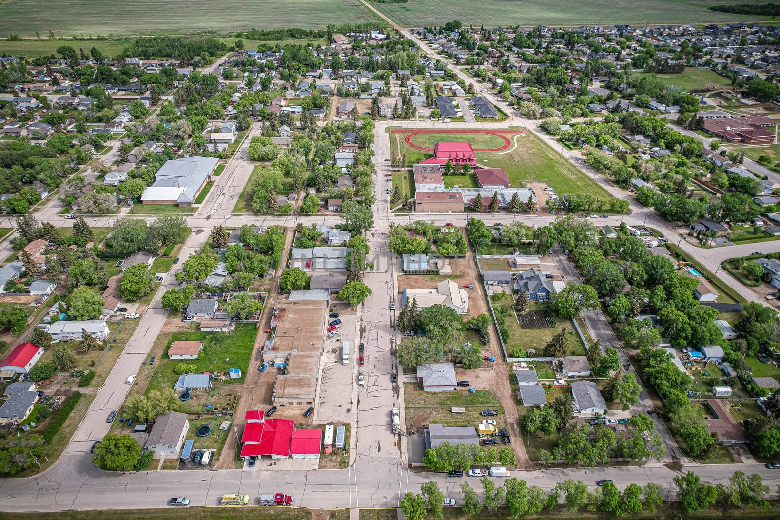 Drone image capturing the town of Dalmeny in Saskatchewan during the summer season, showcasing its vibrant greenery and serene atmosphere