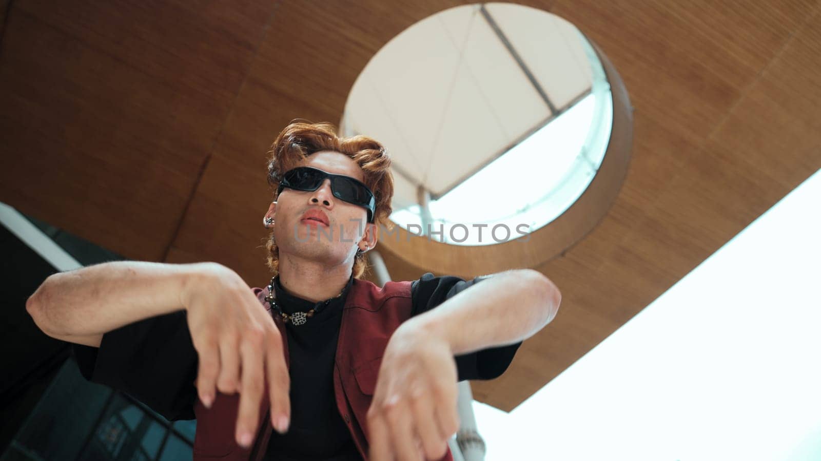 Modern dancer posing at camera with confident with low angle camera. Portrait of young hip hop dancer dancing while wearing in hip hop style. Outdoor sport 2024. Motion shot. Freestyle. Endeavor.