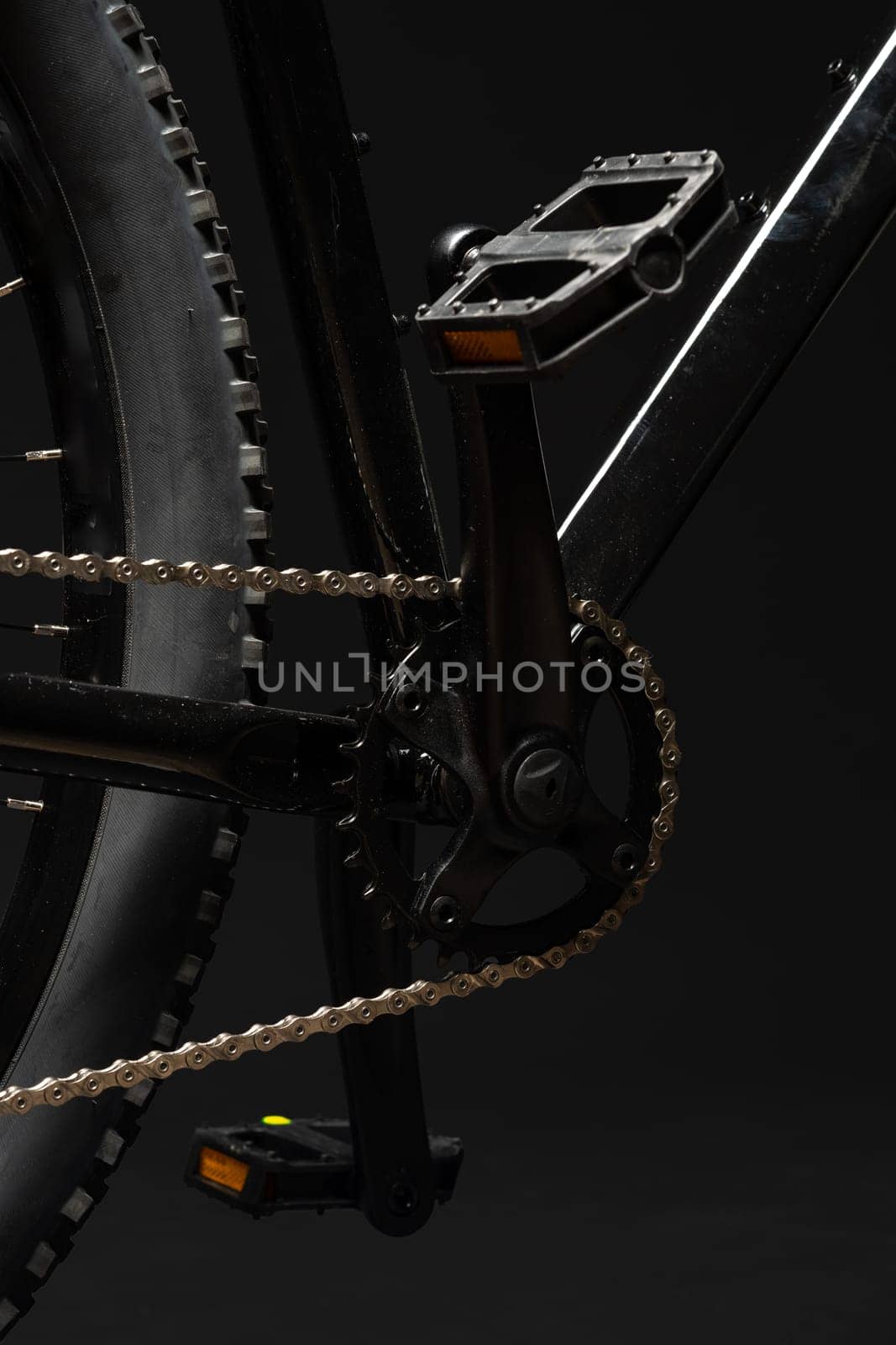 New bicycle chain part close up on black backgroundview photo