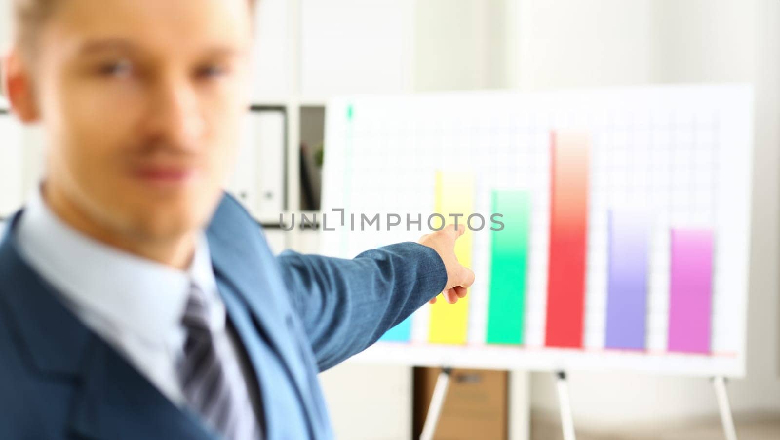 Man in suit point with arm in stats graph in office closeup. Stock exchange market advisor sale examination industry profit research occupation account career present ambition negotiation study trade