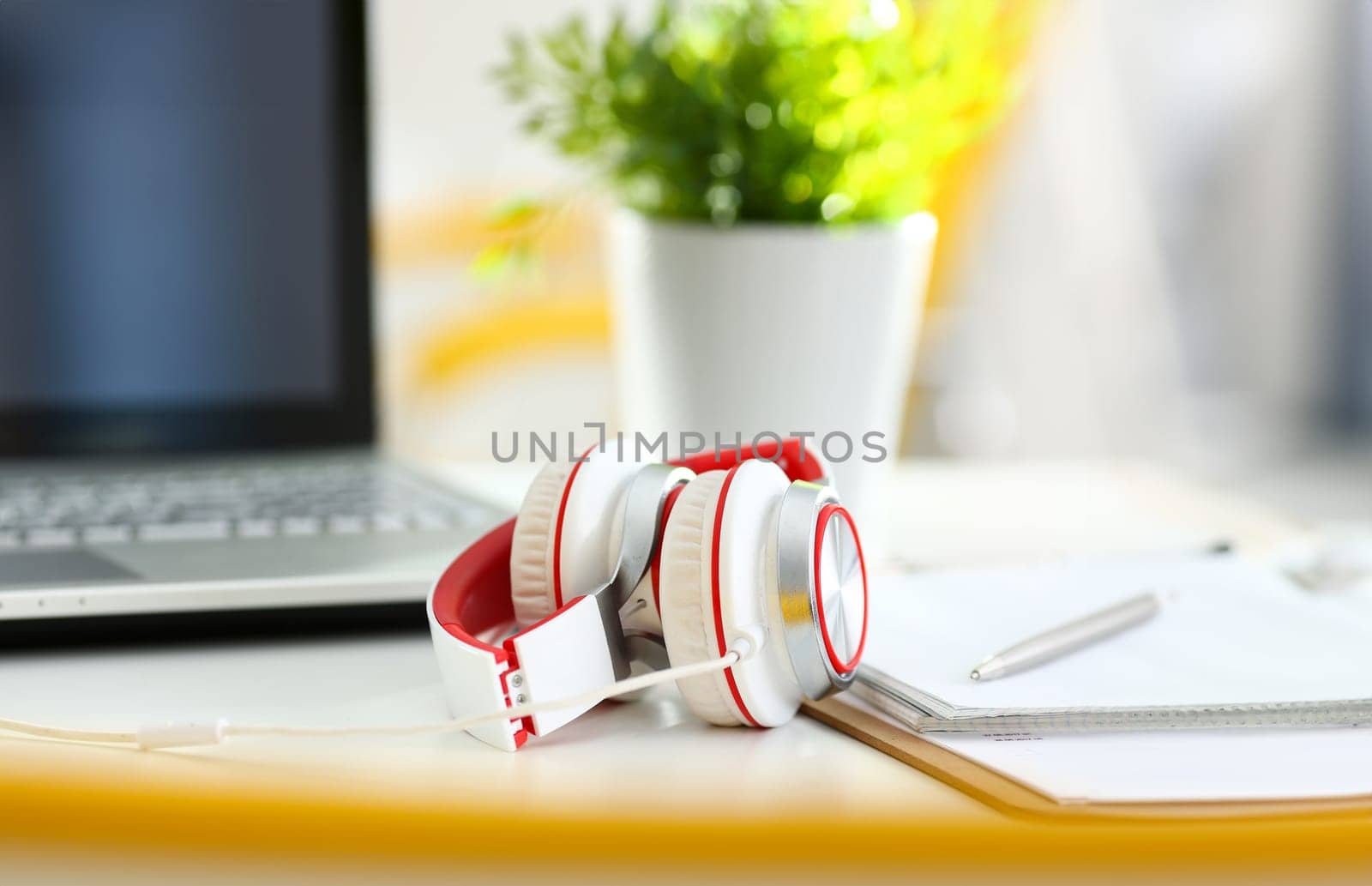 Empty remote office workplace with laptop pc and headset closeup. Receptionist or secretary of contact data center desktop keyboard device desk table ip telephony or callcenter voice message system