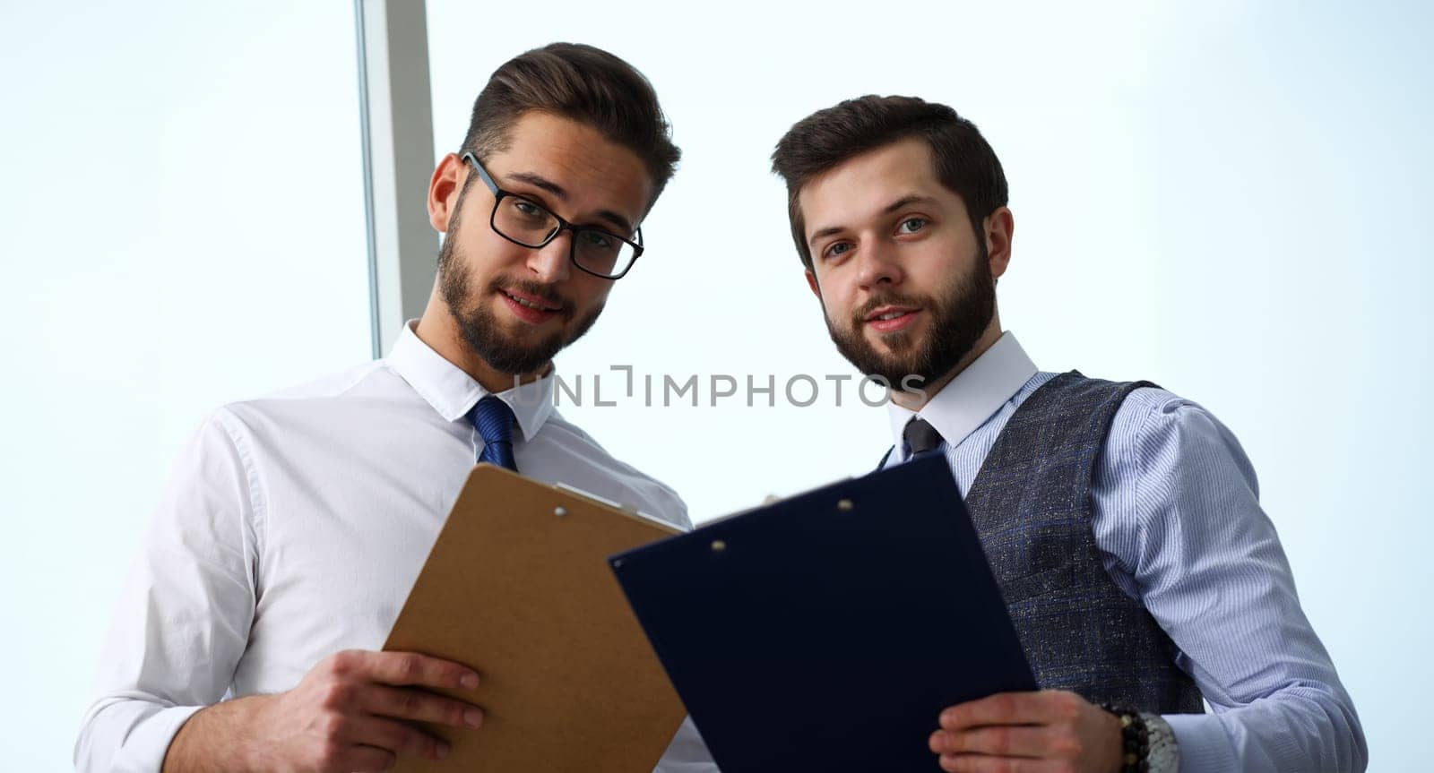 Group of modern businesspeople in office debate on financial issue hold in arms documents portrait. Success assessment human resources data analysis person