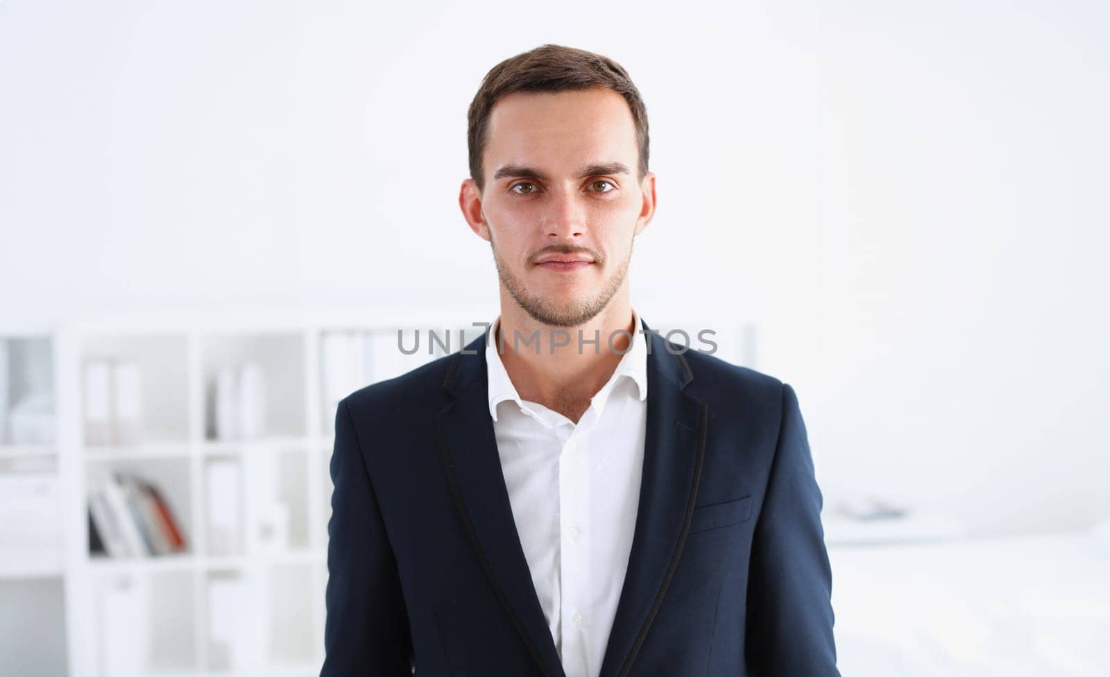 Handsome man in suit and tie look in camera hands crossed on chest background. White collar dress code modern office lifestyle graduate college study profession idea coach train concept