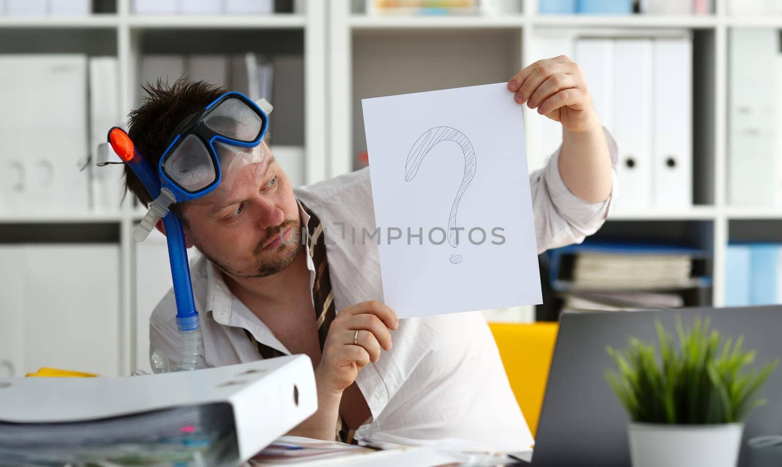 Man wearing suit and tie in goggles and snorkel hold in arm paper with big question sign at workplace in office portrait. Count days to leave annual day off workaholic tourism resort idea ticket sale