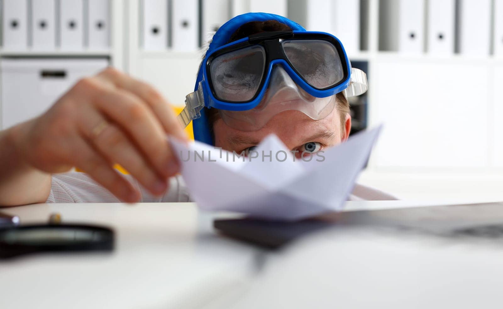 Man wearing suit and tie in goggles and snorkel play with paper ship in office portrait. Count days to leave annual day off workaholic freedom fun tourism resort idea ticket sale concept