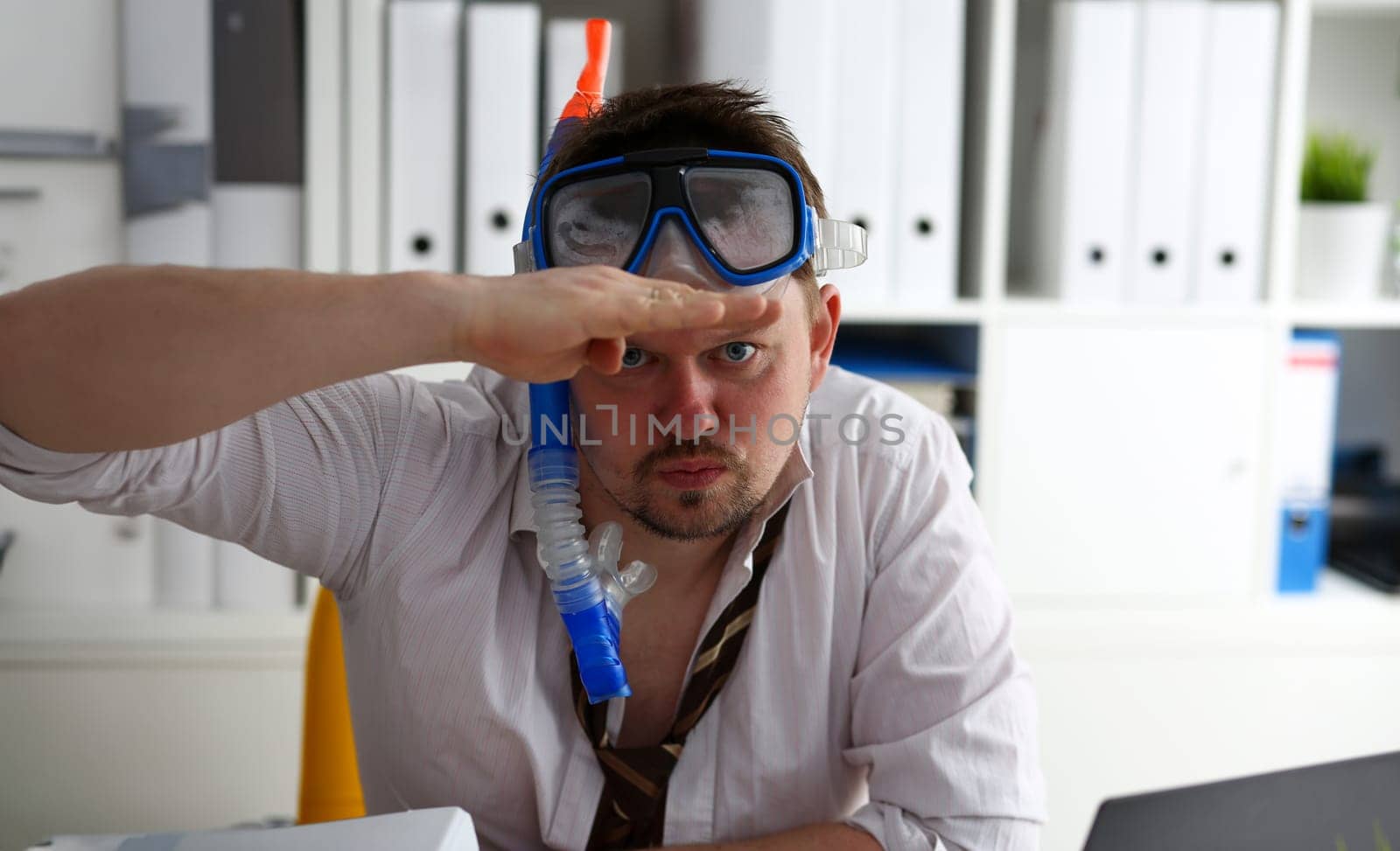 Man wearing suit and tie in goggles with snorkel sit at office workplace ready to take off portrait. Count days to leave annual day off workaholic freedom fun tourism resort idea concept