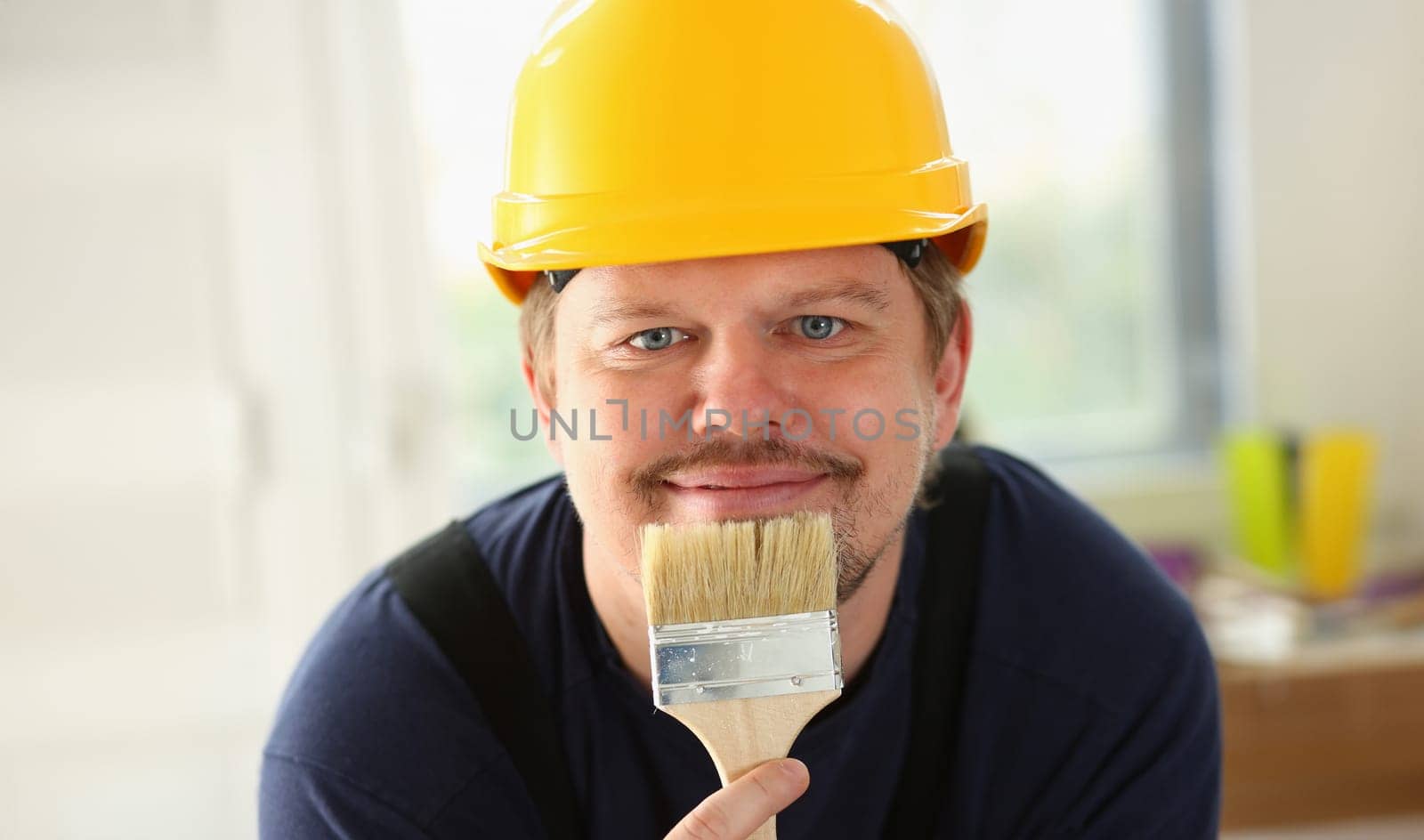 Arm of smiling worker hold brush closeup. Manual job workplace DIY inspiration improvement fix shop yellow helmet hard hat joinery startup idea industrial education profession career concept