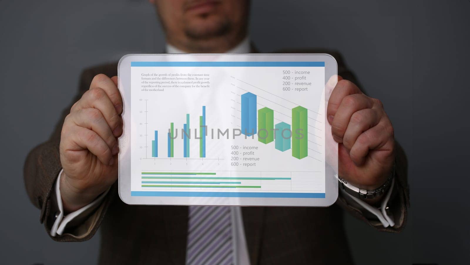 Businessman holding tablet in hands with diagramm on display home office setting. Calculation of family expenses social income population freelance irs situation growth research concept