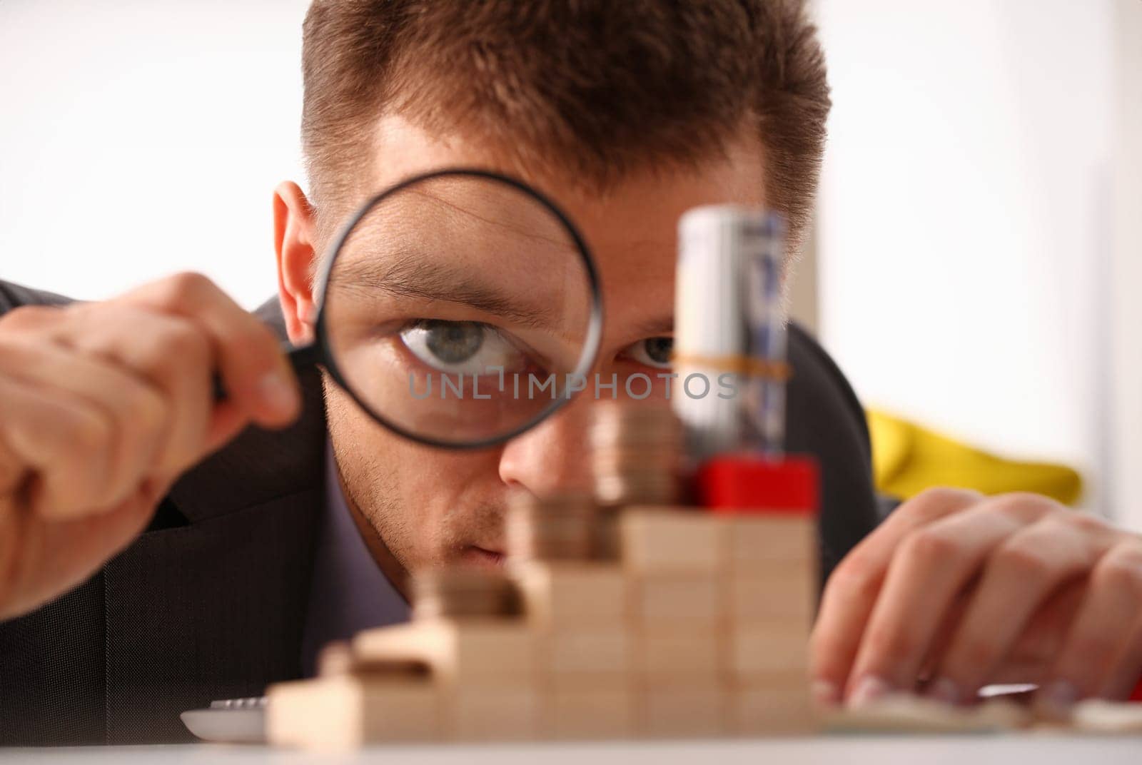 Businessman holds in hand black lens looks with an eye at tower of coins glass portrait closeup. Searches online best schedule 404 page not found concept.