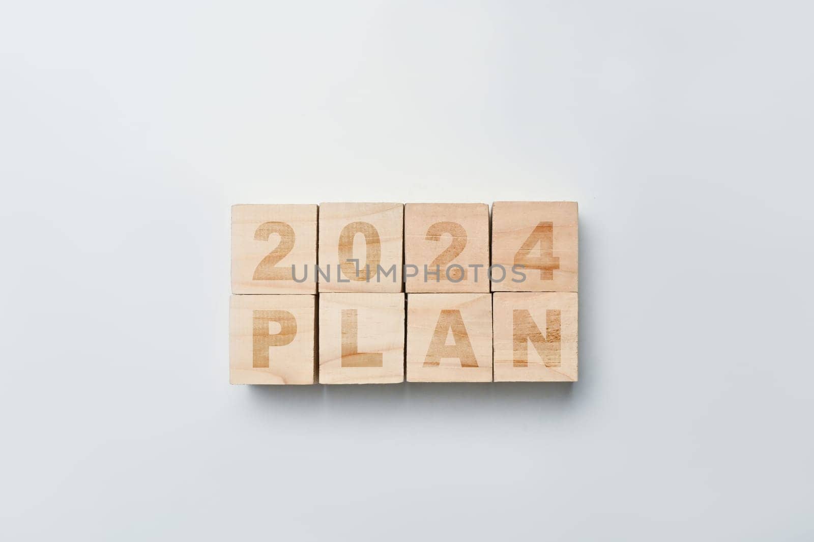 Wooden cube blocks with 2024 PLAN word on white background. Business action plan, goals and strategy concept.