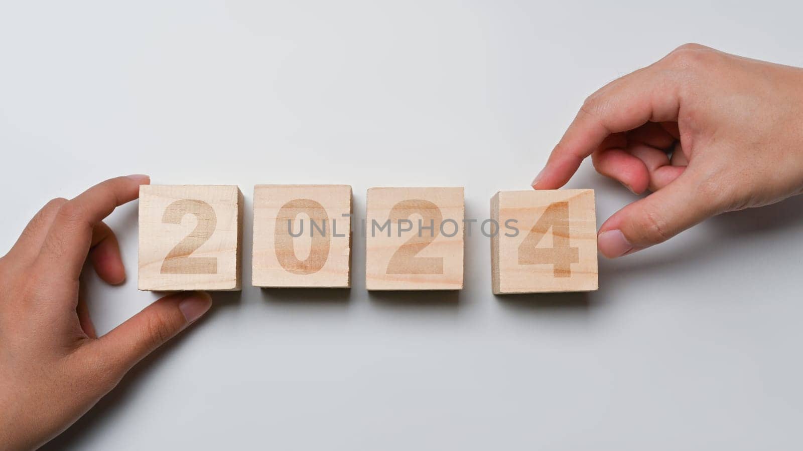 Hand flipping wooden block cube to 2024. Starting to new year and business vision concept by prathanchorruangsak