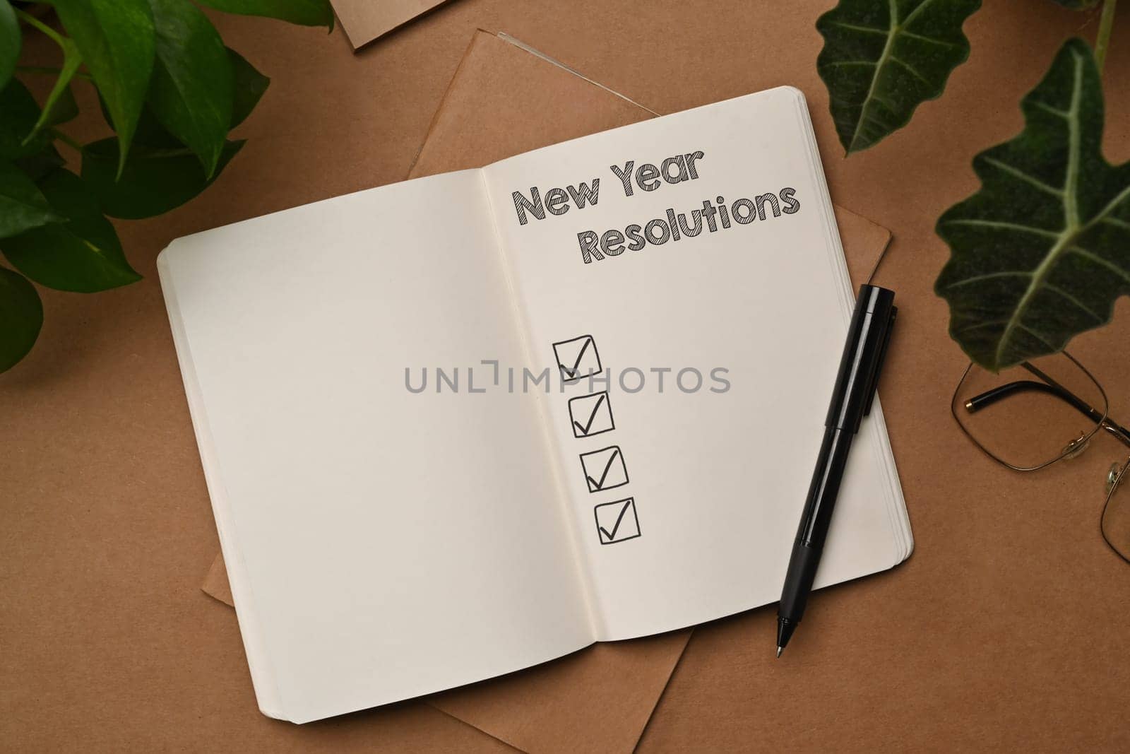 2024 New Year resolutions with list on notebook. Self improvement and development concept by prathanchorruangsak