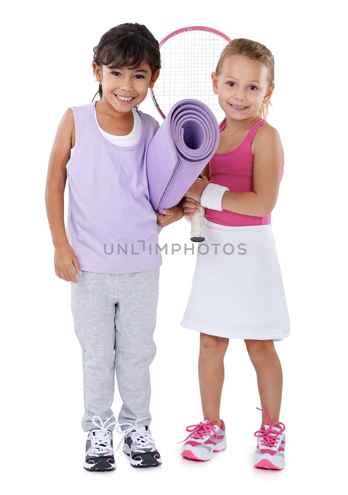 Tennis, sports and portrait of children on a white background for training, workout and exercise. Fitness, friends and isolated young kids with yoga mat, racket and equipment for hobby in studio by YuriArcurs