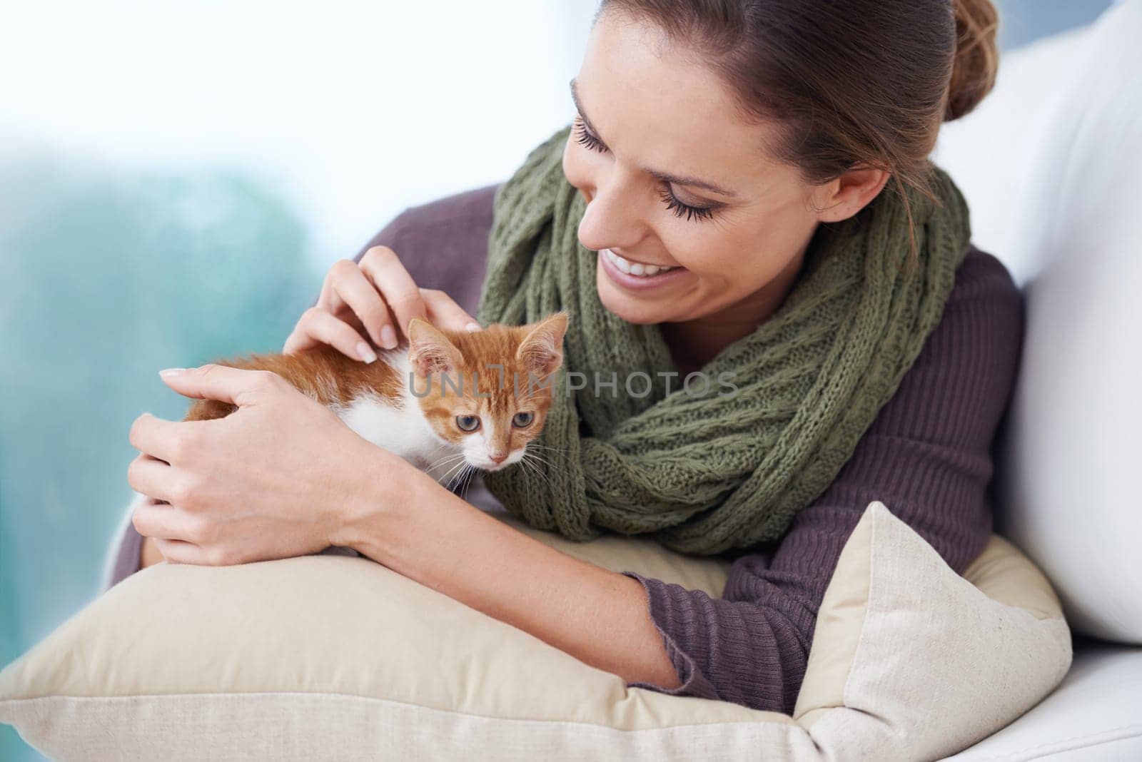 Happy, sofa and woman with kitten in home for bonding, friendship and relax together in house. Animal care, pets and person with adorable, cute and young cat on couch for playing, affection and love.