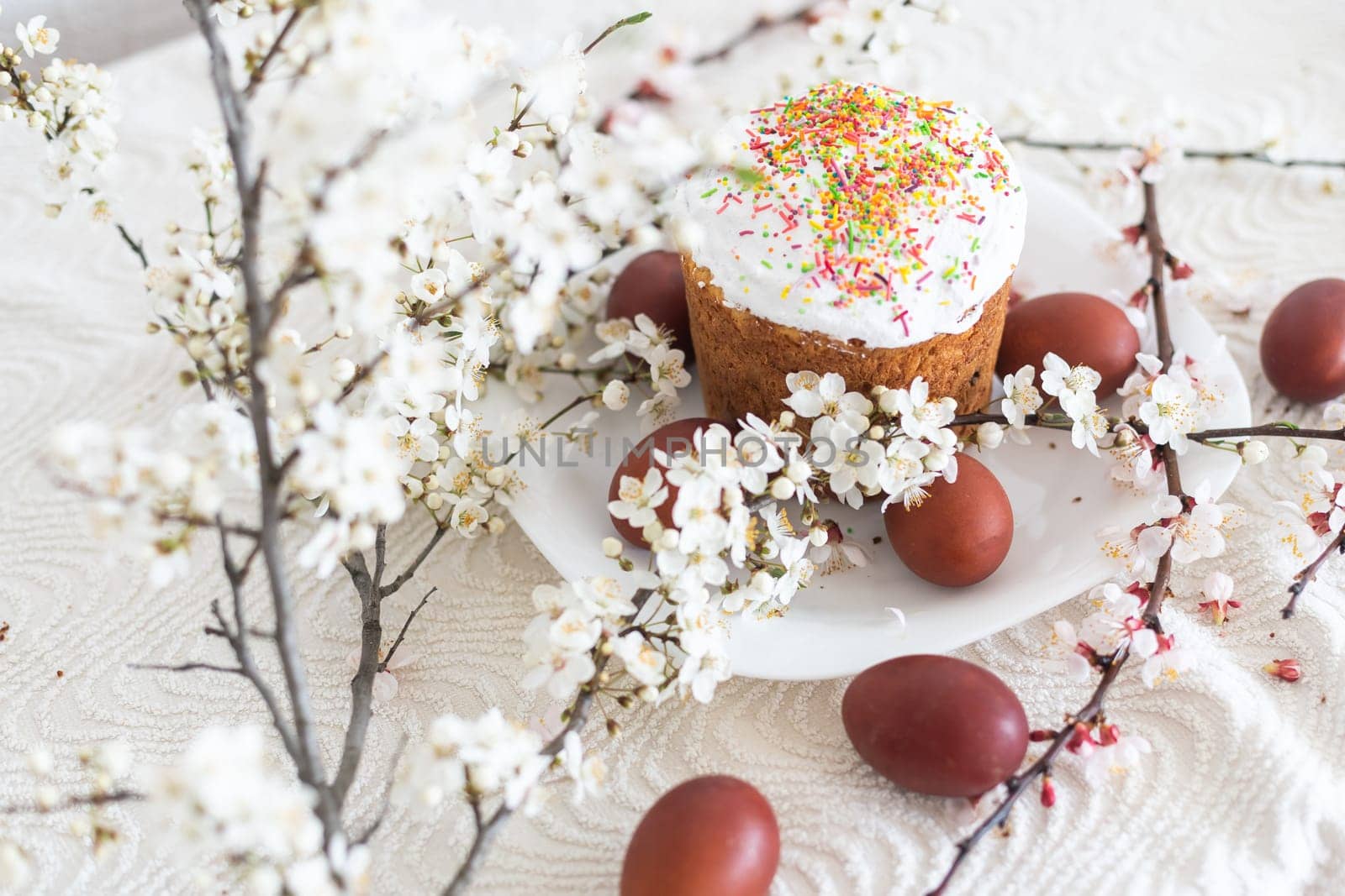 Traditional Easter cakes and colored eggs. A branch tree.