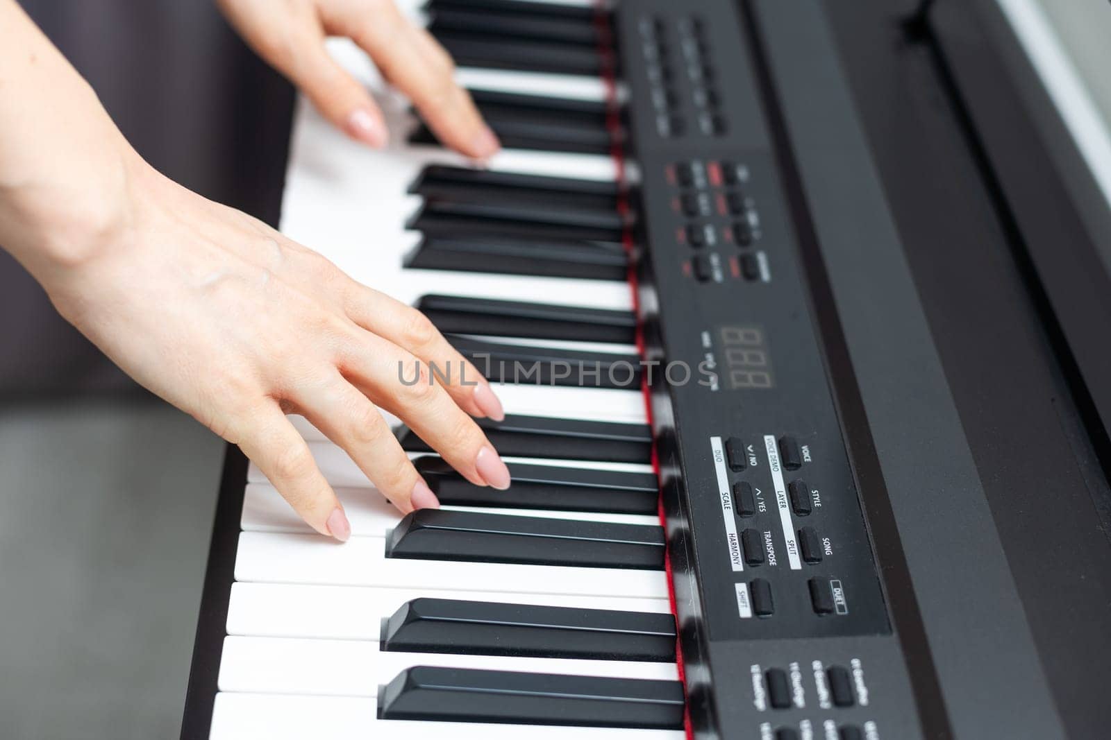 keyboard and hands playing the piano. High quality photo