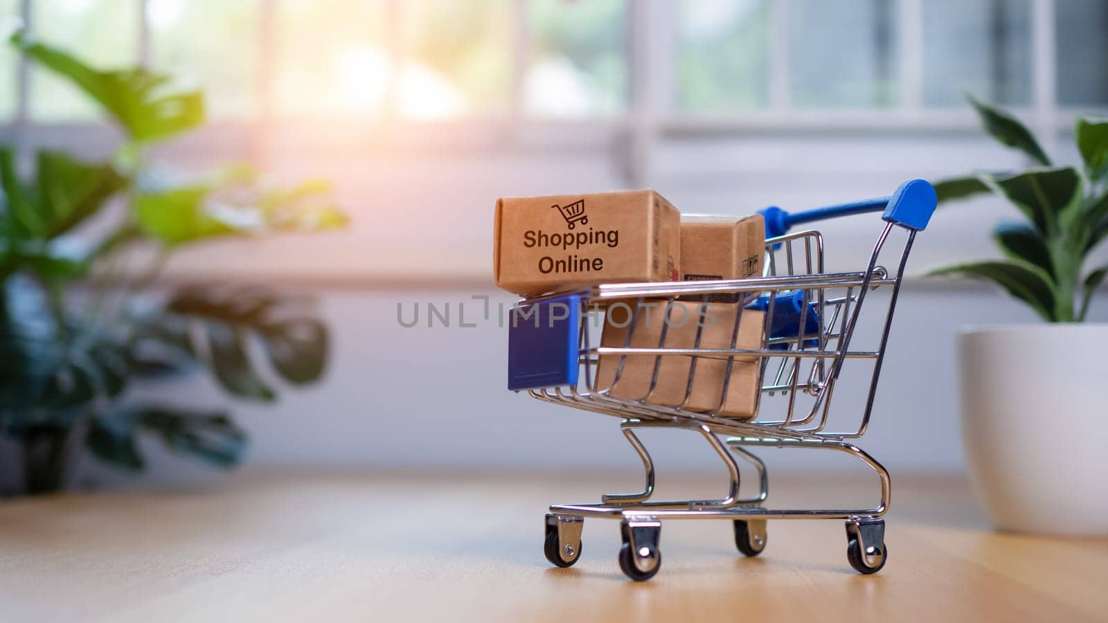 Online shopping, Product package boxes in cart with shopping bag  delivery concept, Shopping service on The online web and offers home delivery, online shopping and delivery concept. by Unimages2527