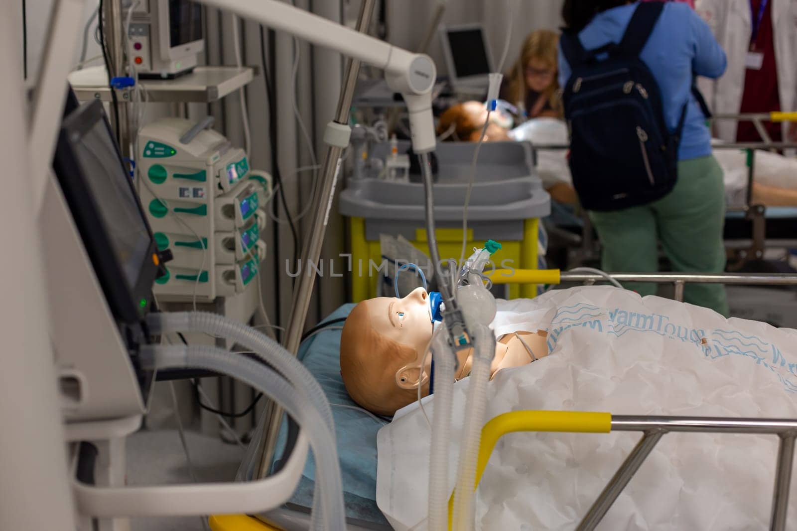 Moscow, Moscow region, Russia - 03.09.2023:Medical mannequin in a simulation of intensive care, with healthcare professionals in the background