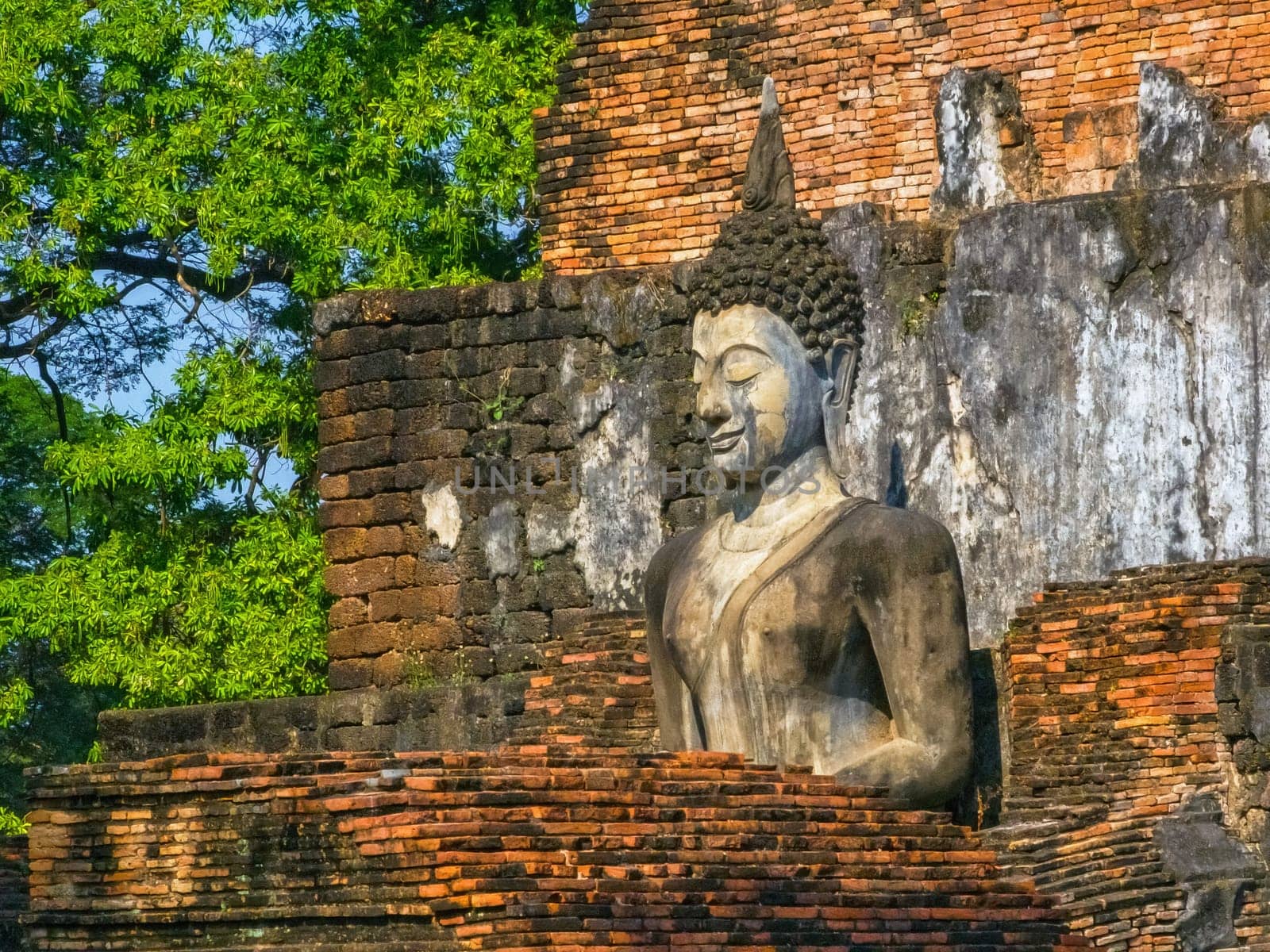 Buddha at Wat Mahathat temple in Sukhothai historical park by day, UNESCO World Heritage Site, Thailand