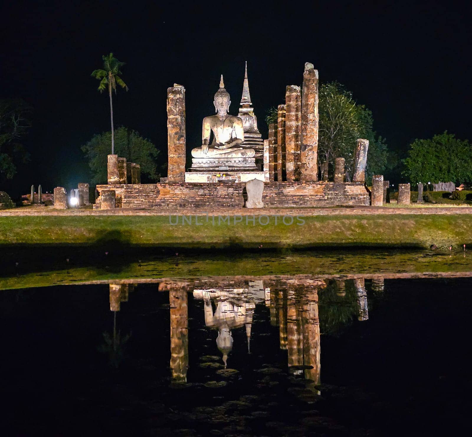 Buddha at Wat Mahathat temple in Sukhothai historical park by night, UNESCO World Heritage Site, Thailand