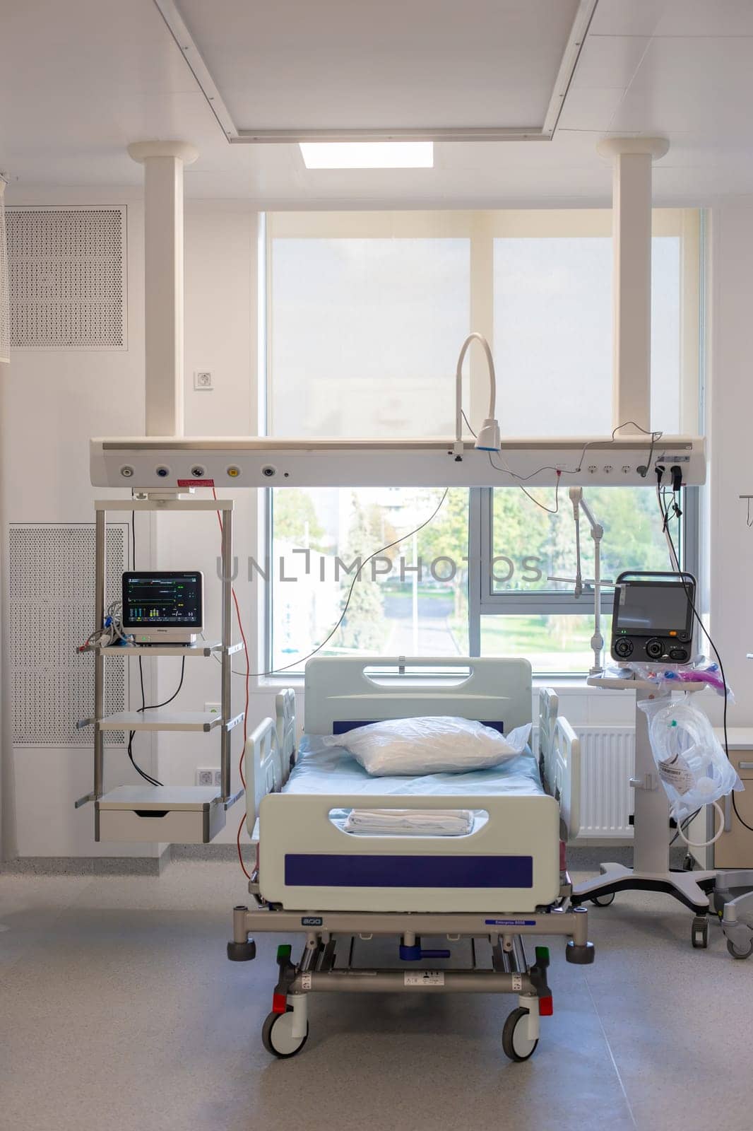 Moscow, Moscow region, Russia - 03.09.2023:A well-equipped hospital room with an empty bed, medical monitors, and various devices.