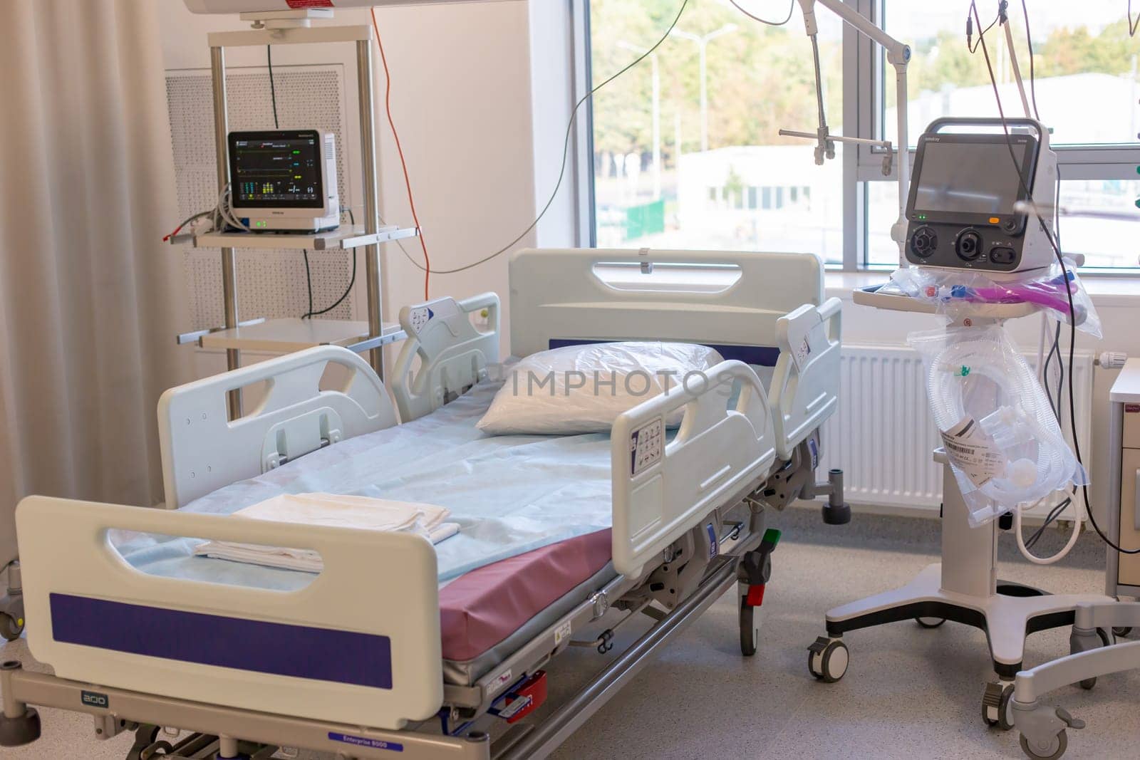 Moscow, Moscow region, Russia - 03.09.2023:A well-equipped hospital room with an empty bed, medical monitors, and various devices.