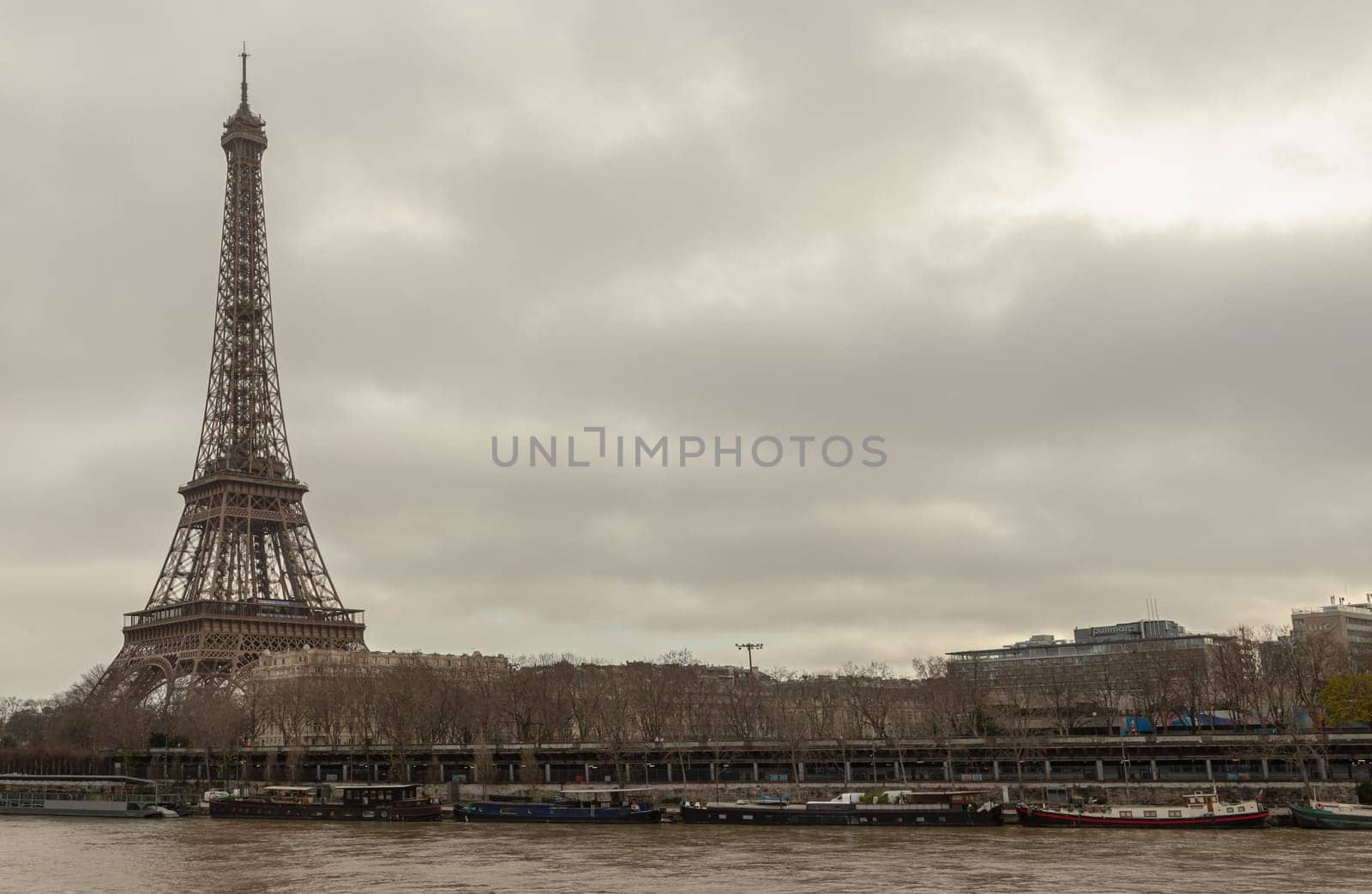 France, Paris - Jan 4, 2024 - Nice scenery of Eiffel Tower and Seine River in Paris at Afternoon. Destinations in Europe. Space for text, Selective focus.
