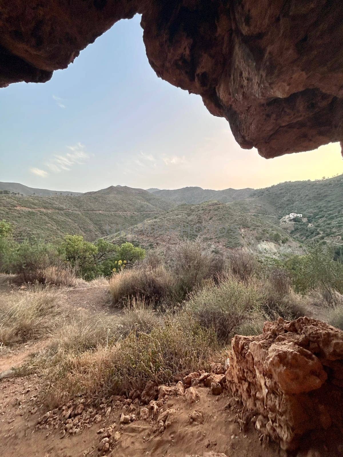 A view from inside of a cave in the mountains by DailySF