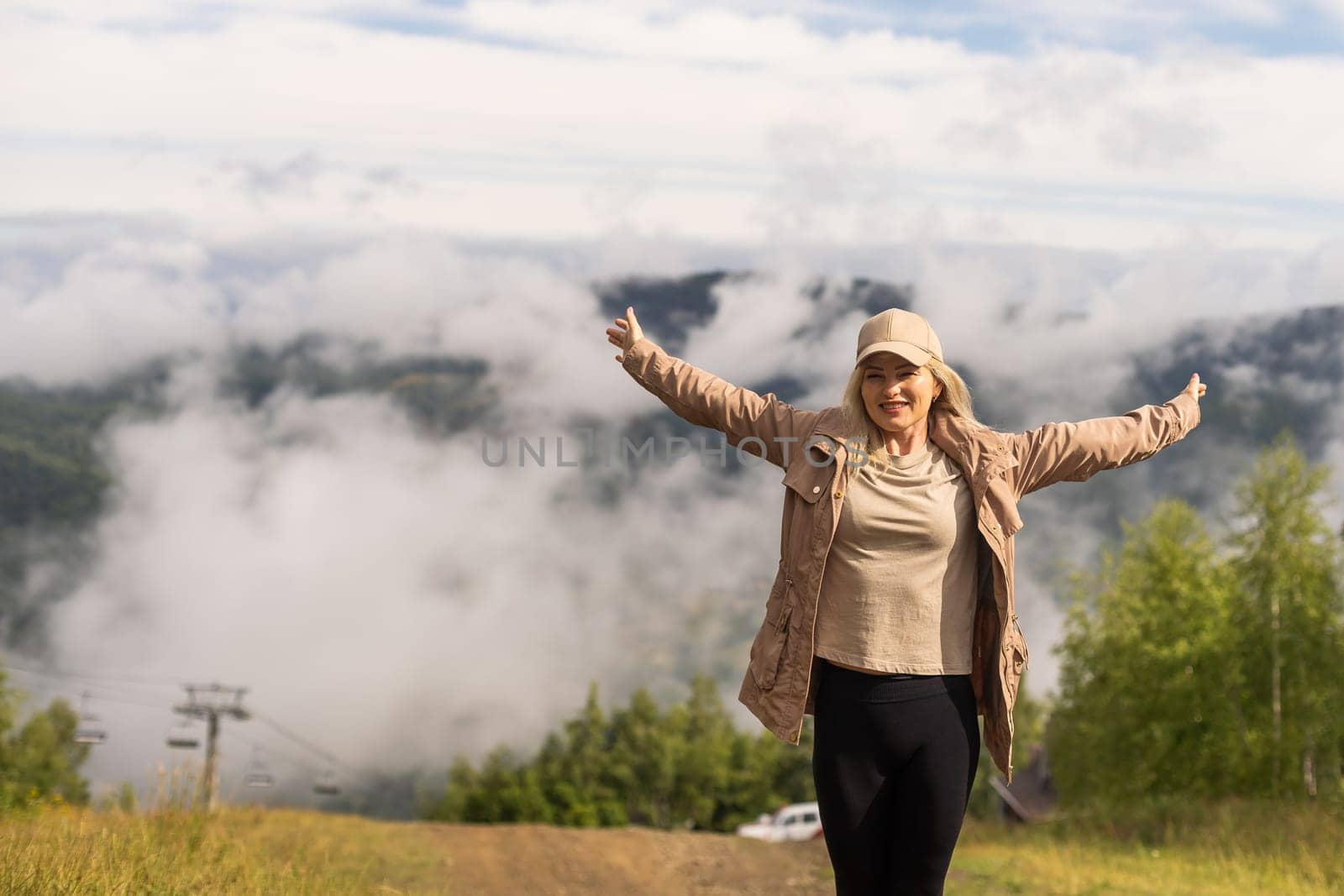 Beautiful young woman with backpack walking on meadow. Portrait of hiker girl outdoor by Andelov13