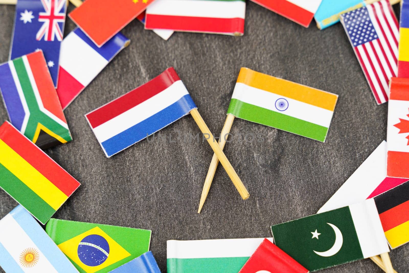 Policy. National flags of different countries. The concept is diplomacy. In the middle among the various flags are two flags - India, Netherlands