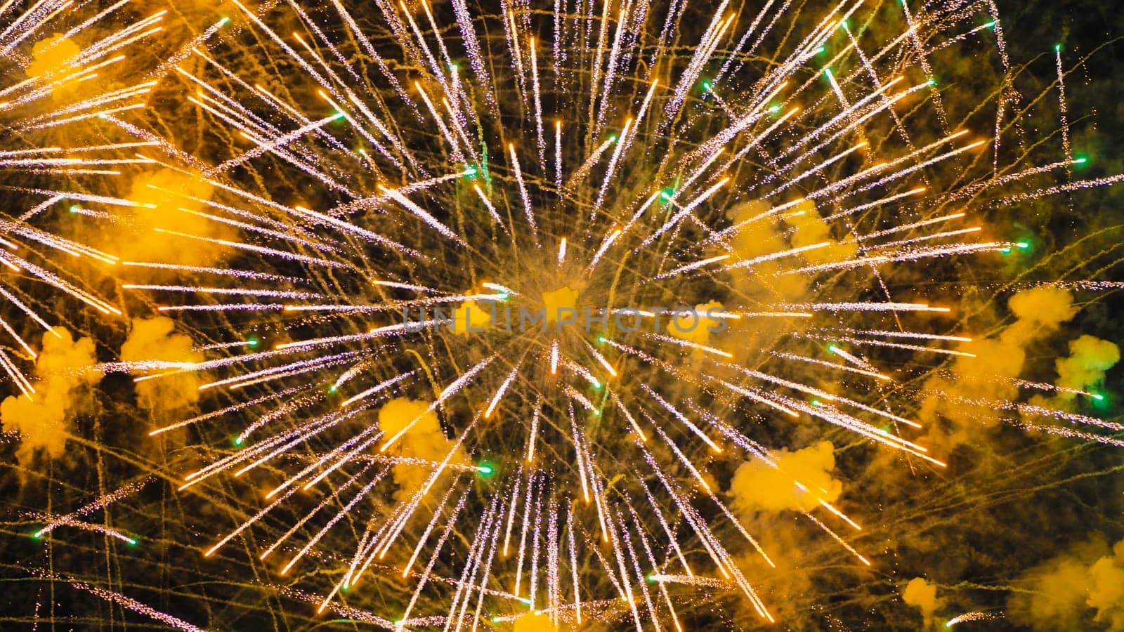 A colourful explosion of yellow fireworks in the night sky