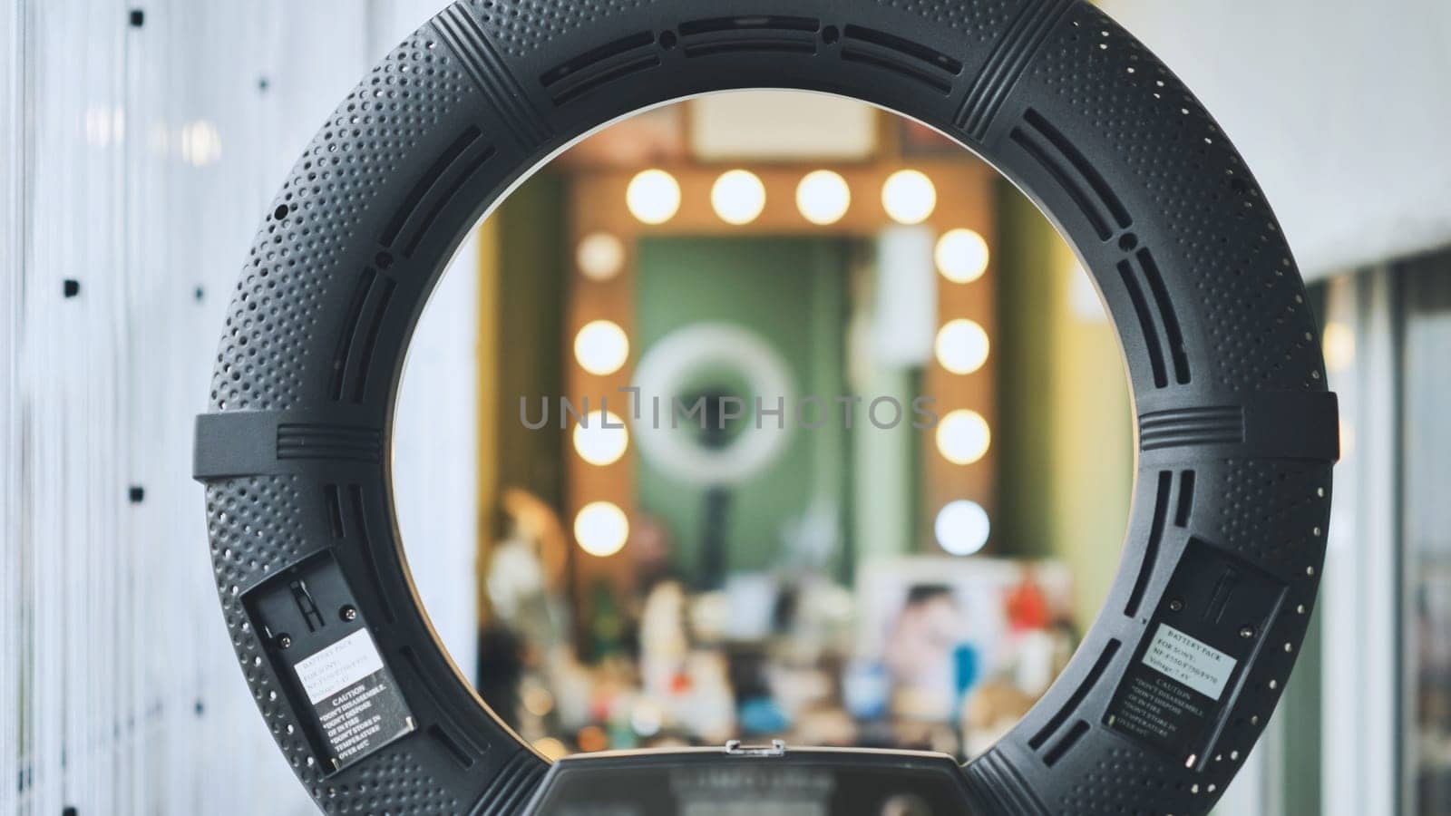 The makeup artist works in the office against a backdrop of circular lighting. by DovidPro