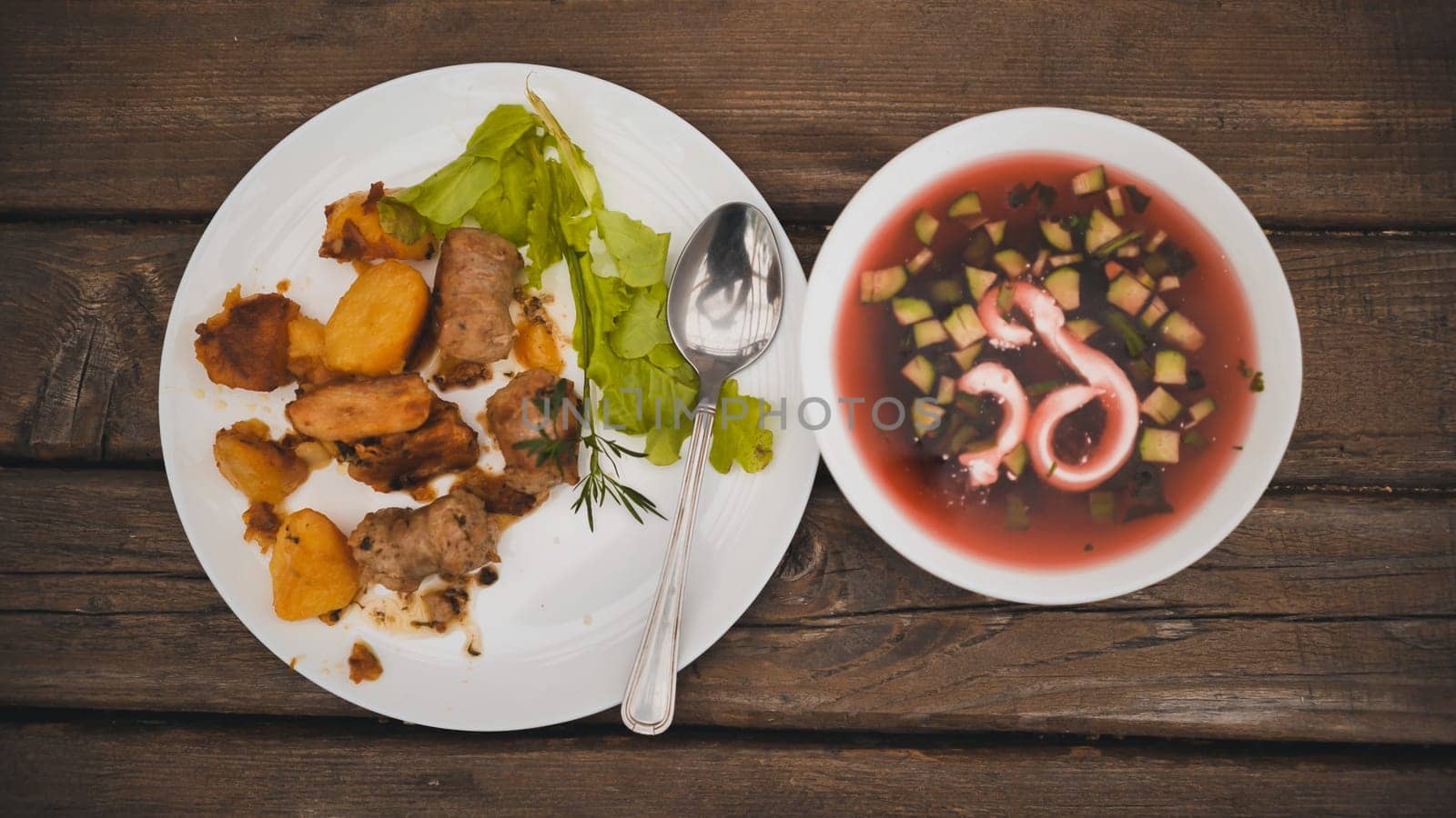 Roast potatoes with meat and red with borscht served for dinner