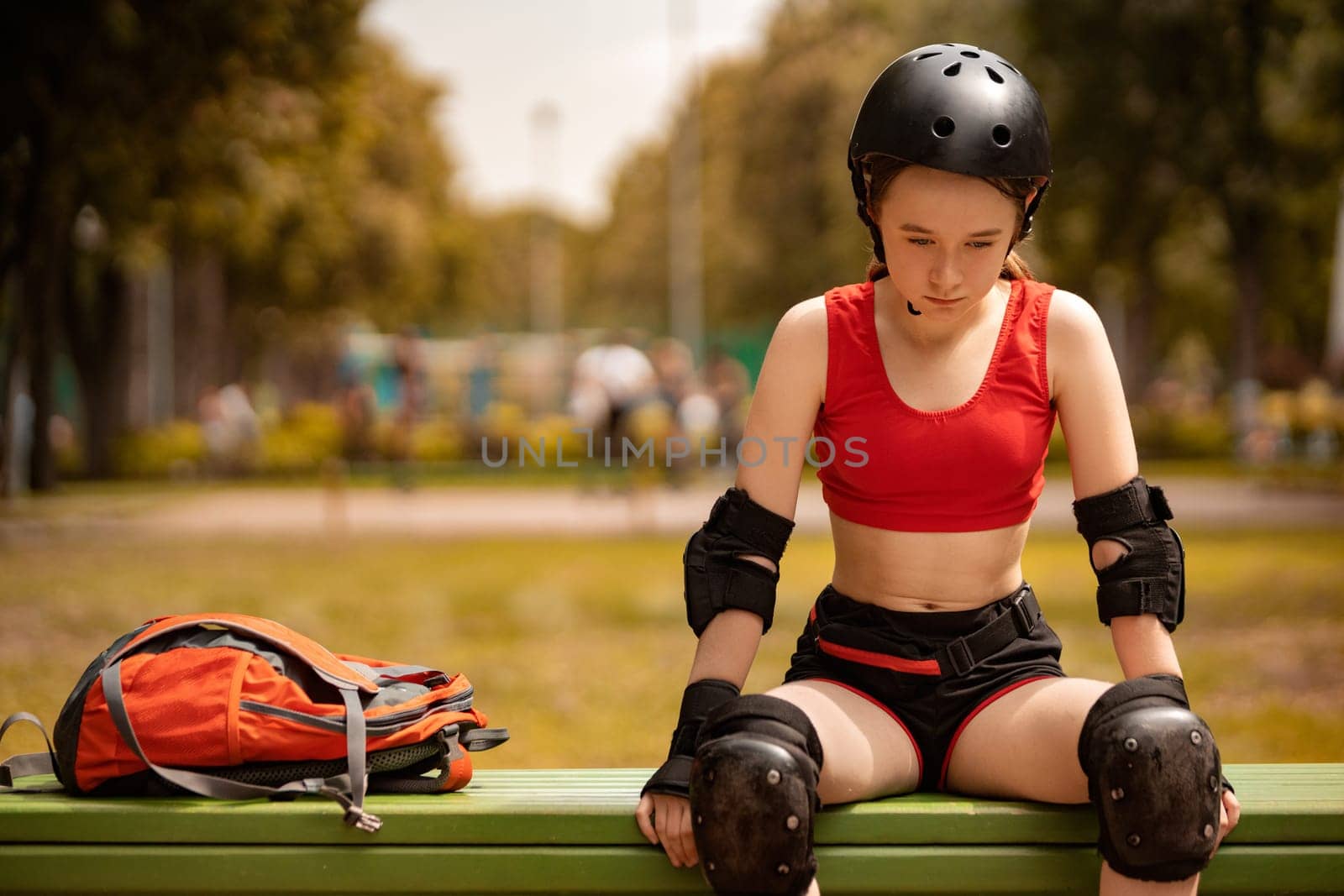 Roller skating girl in park rollerblading on inline skates. Caucasian young woman in outdoor activities. by MikeOrlov