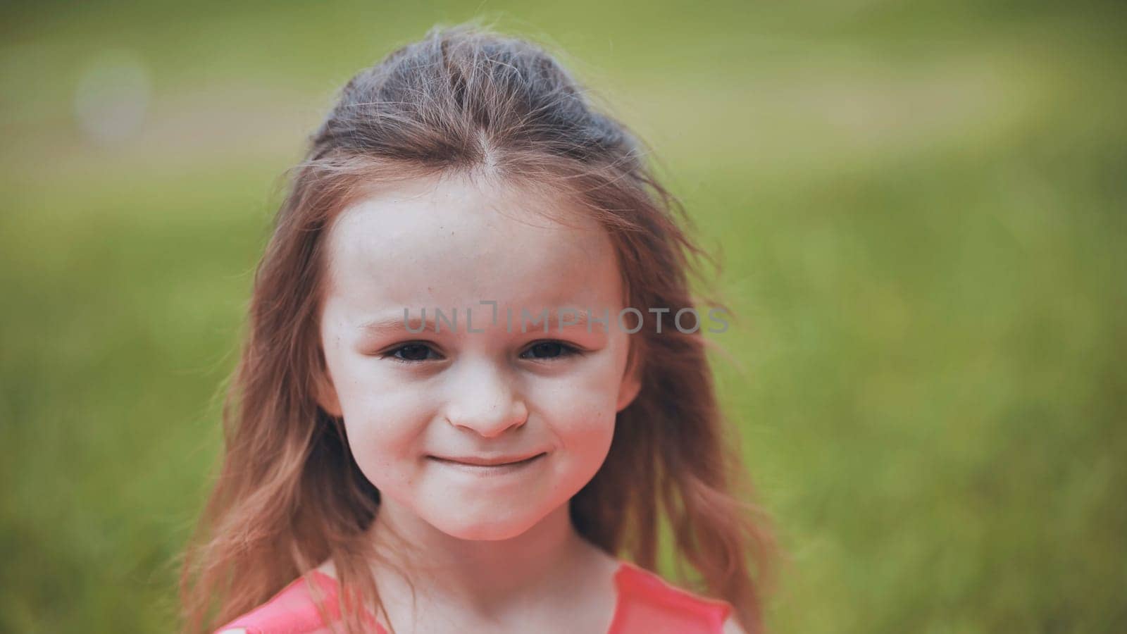 Portrait of a 6-year-old girl in a park in the summer