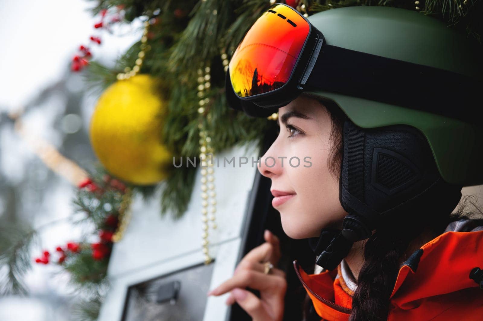 Portrait of a woman in the Alps. Young beautiful caucasian woman in ski goggles looking at the camera with a sexy look.