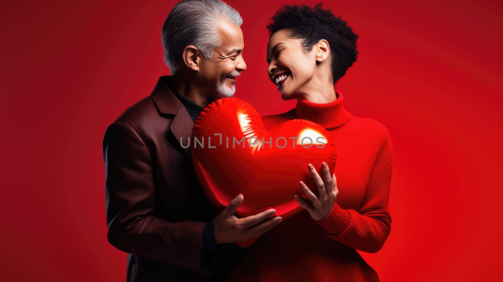 Beautiful couple holding big red glossy heart on red background. St Valentine's Day love