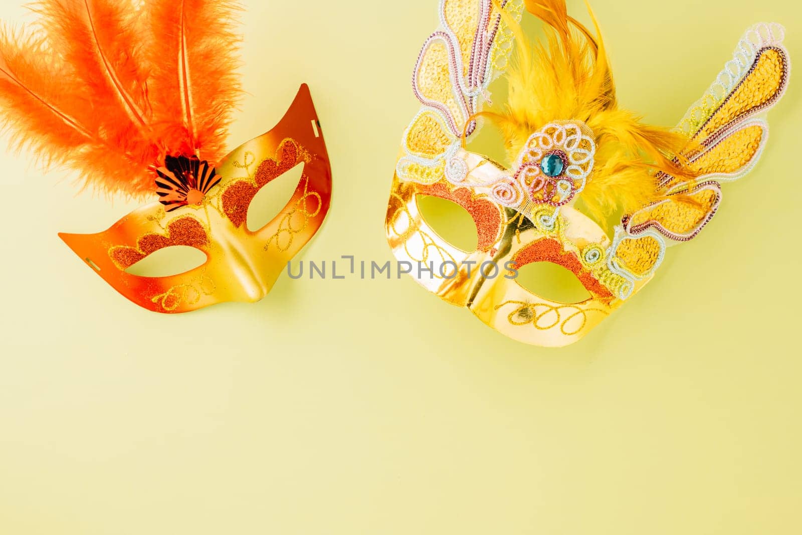 Happy Purim carnival accessories. Top view carnival mask for Mardi Gras celebration isolated on pastel green background, jewish holiday, Purim in Hebrew holiday