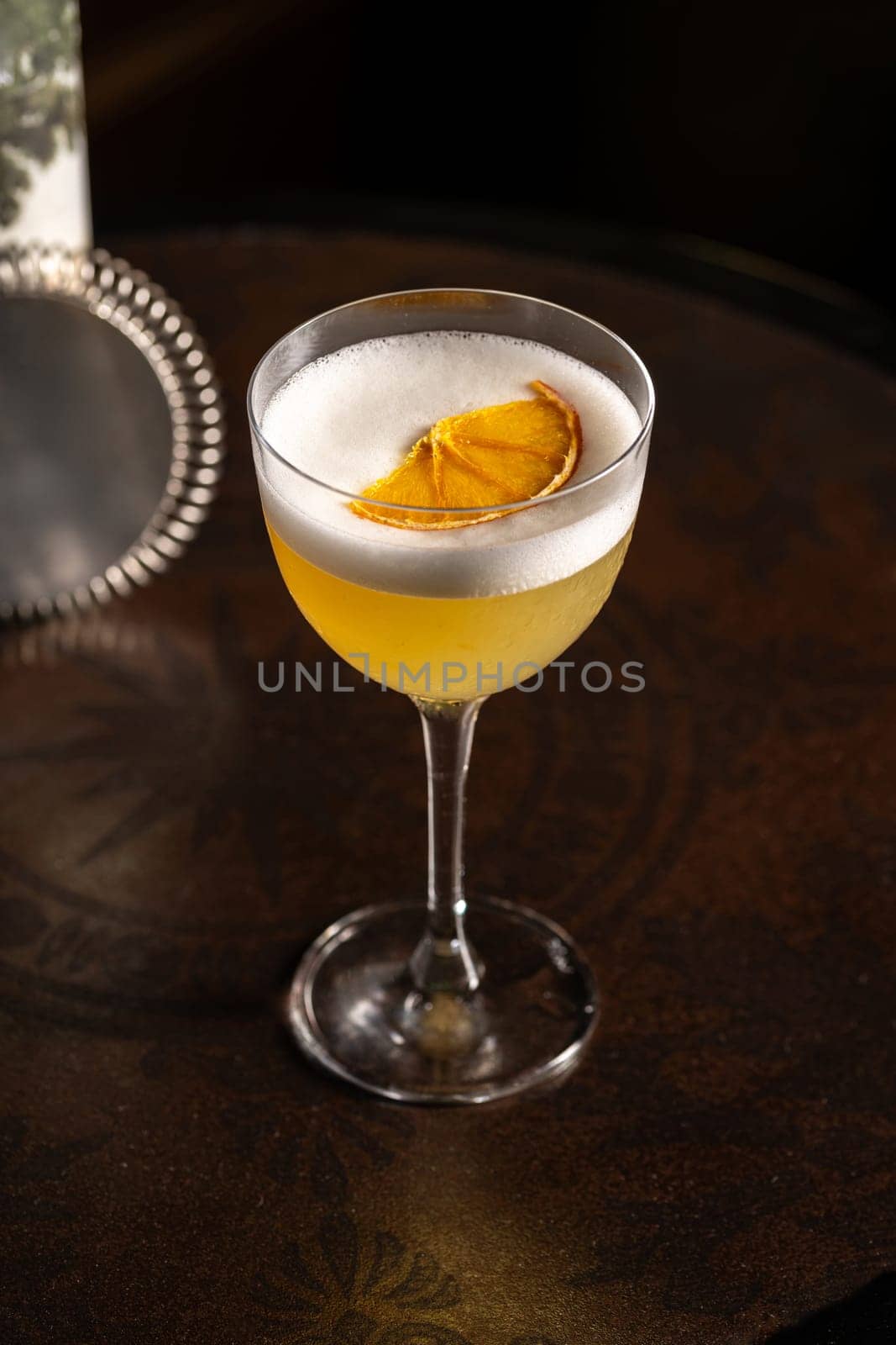 Luxury cocktail on the wooden table on a dark background by Sonat