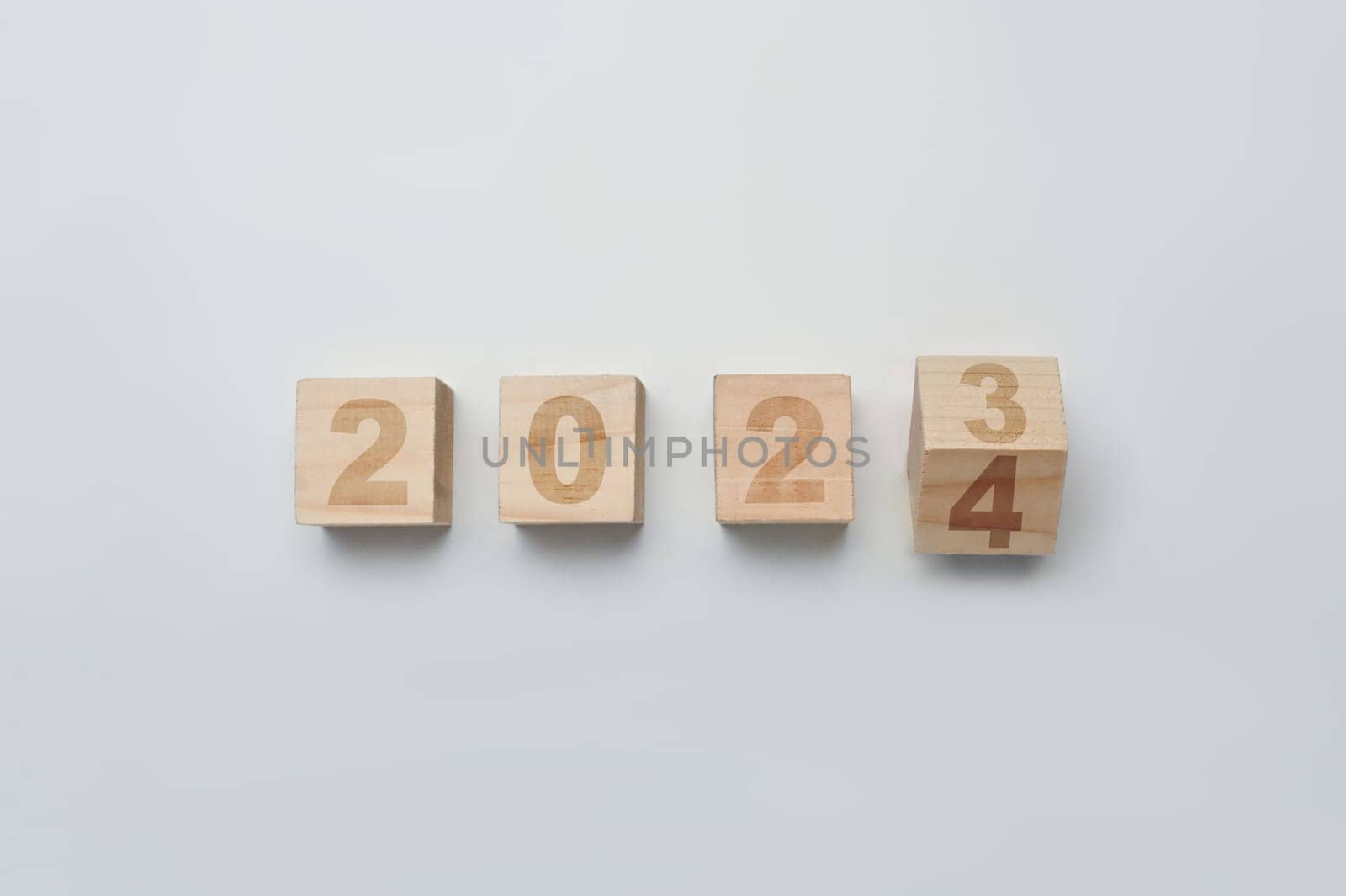 Wood cubes or blocks turning year from 2023 to 2024. Start new year, beginning and business target strategy concept by prathanchorruangsak