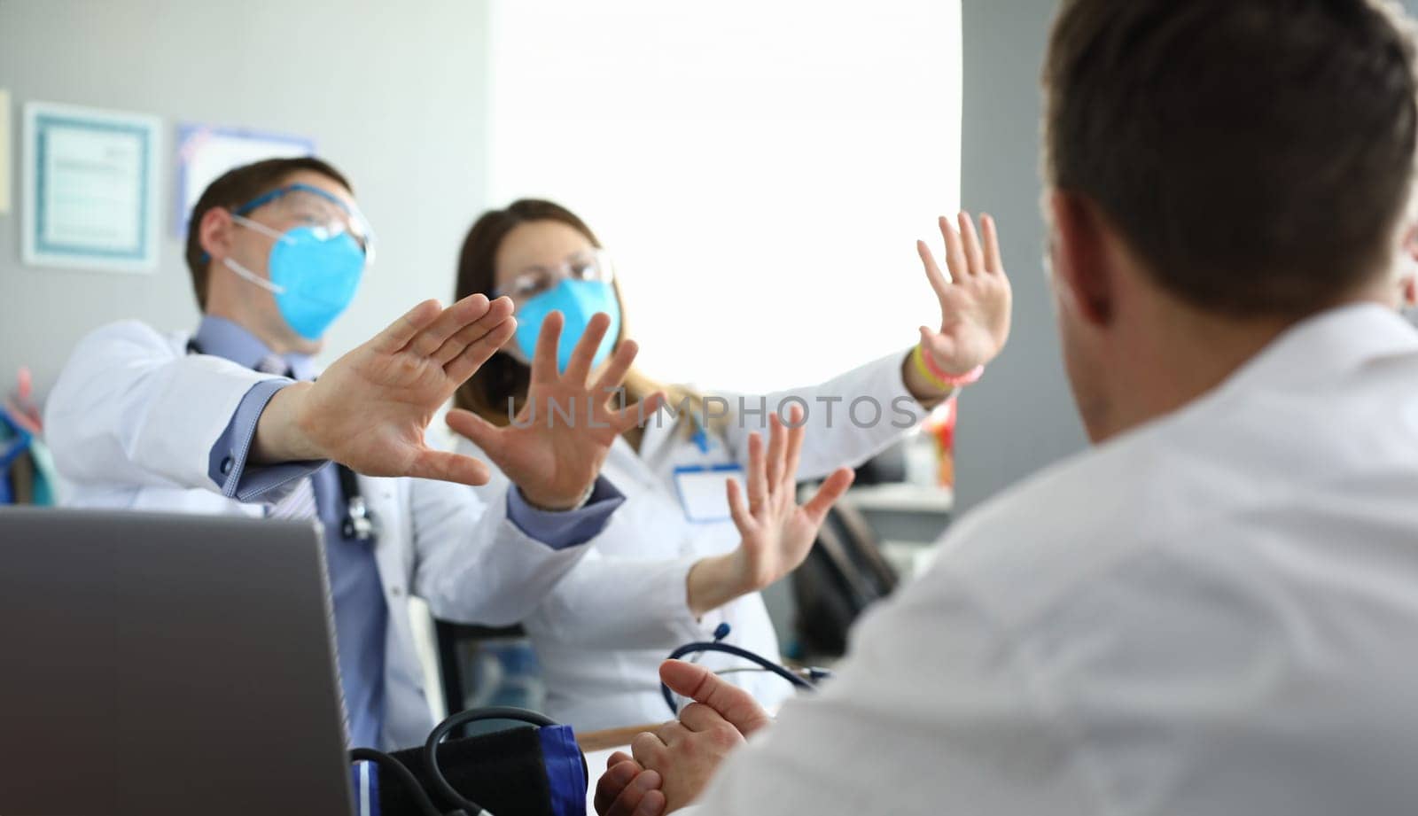 Doctors in medical masks disagree with colleagues by kuprevich