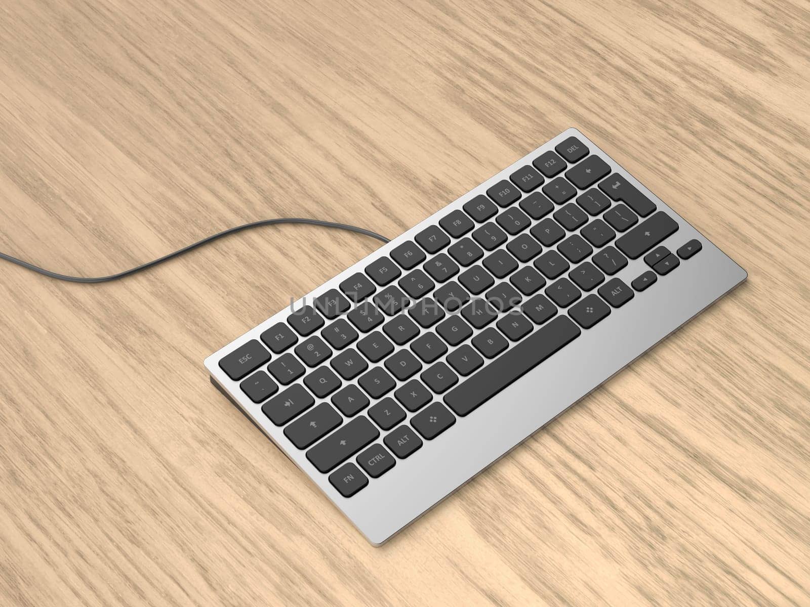 Modern wired computer keyboard on a wooden desk