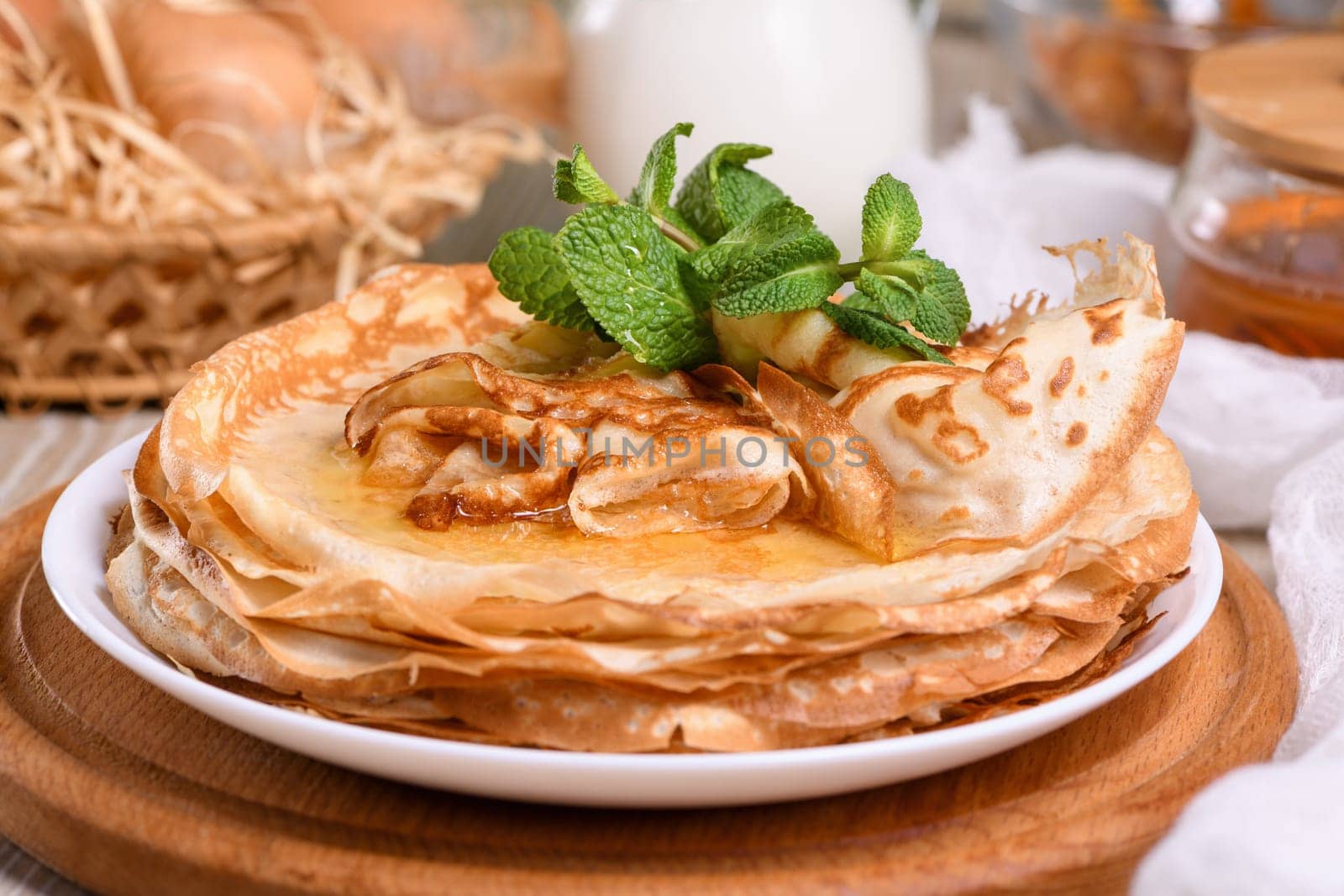 Homemade thin crepe (pancakes) with honey by Apolonia