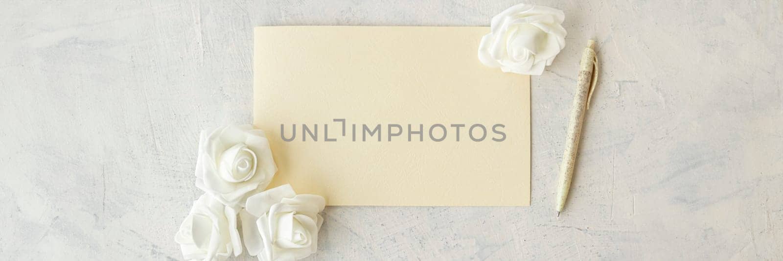 banner of top view of empty card, pen, white flowers on grey background