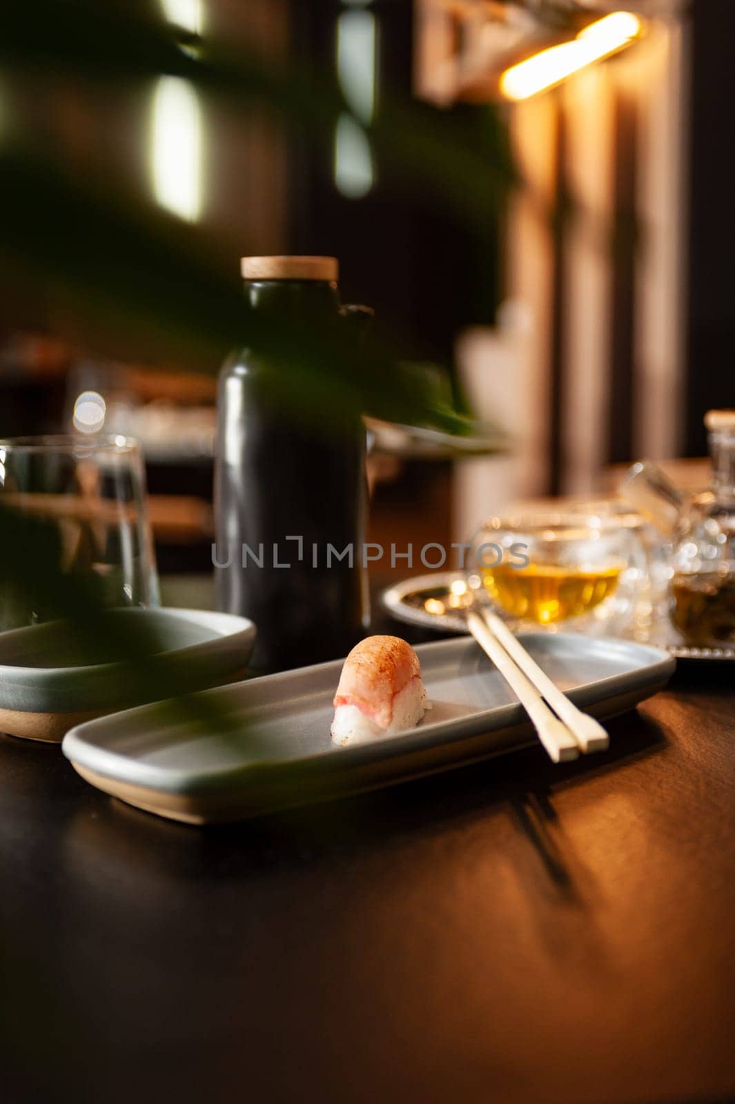 Nigiri tuna tataki on a plate on a table in a sushi bar on a plate close-up. High quality photo