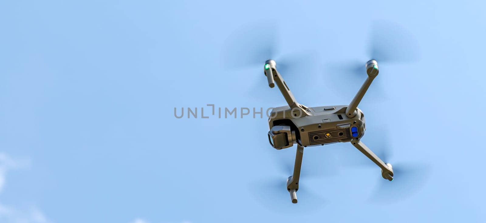 Panoramic view of a flying drone against a blue sky