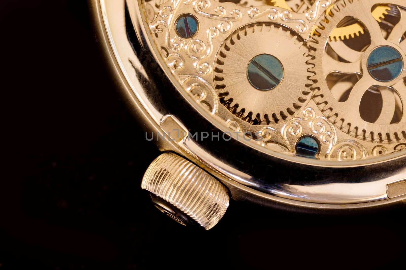 A part of a transparent watch with visible gears