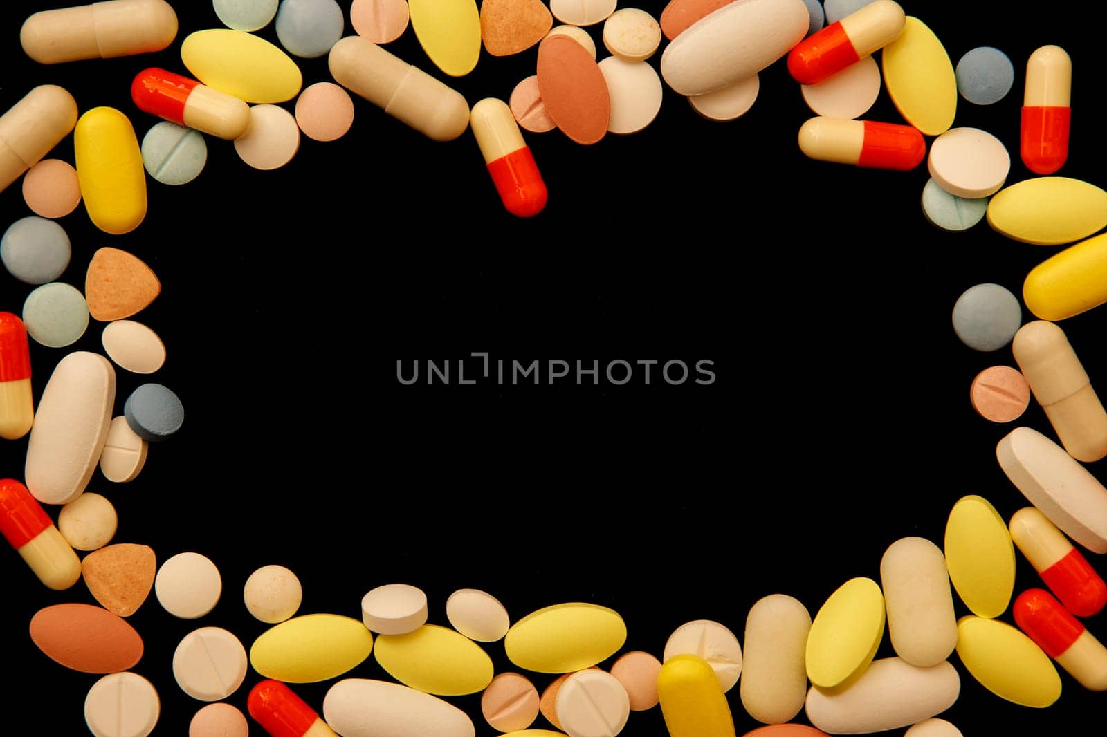 Many different colored drugs and pills around empty space by EdVal