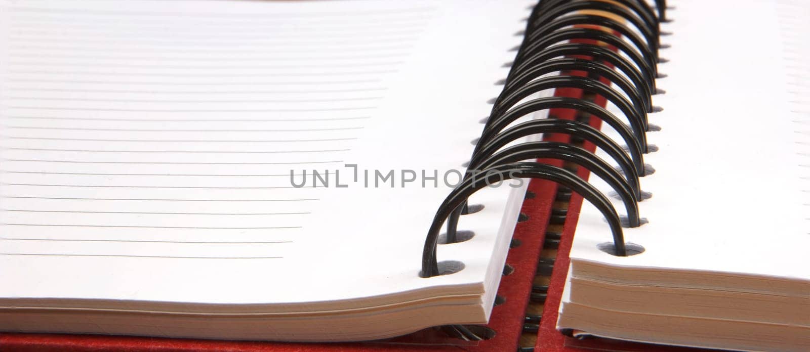 Close up of an open spiral notebook. Banner view
